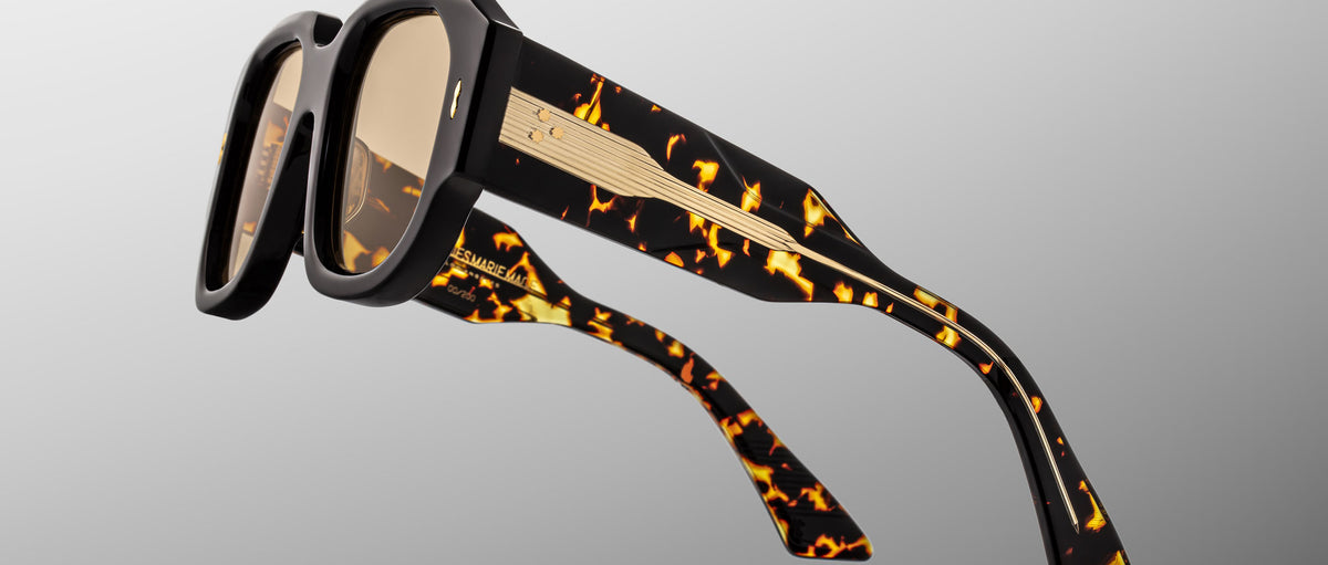 Close-up of Jacques Marie Mage Lacy sunglasses, retro tortoiseshell thick frames, gold temples, front view.
