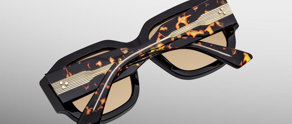 Jacques Marie Mage Lacy sunglasses with thick tortoiseshell frames, gold accents, and brown lenses, shown from the front angle.