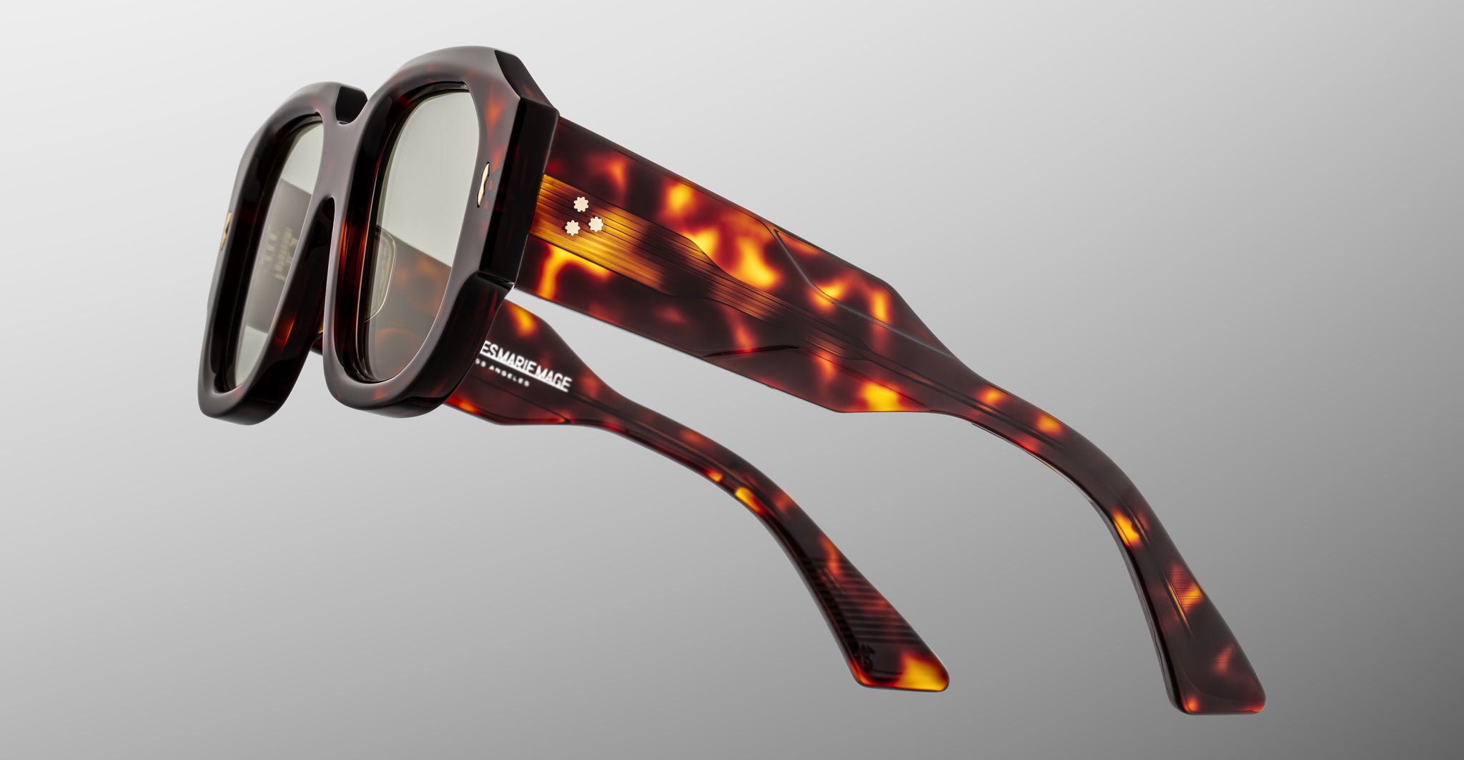Jacques Marie Mage Lacy sunglasses, shown from a front angle, have thick brown tortoiseshell square frames and branded temples.