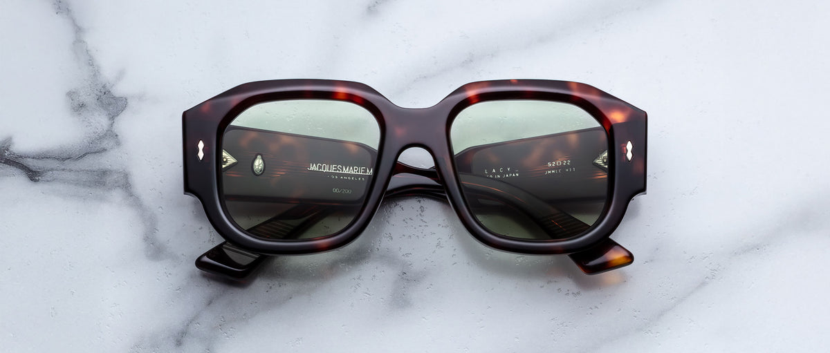 Jacques Marie Mage Lacy sunglasses with green polarized lenses, shown from above, display the brand and model clearly.
