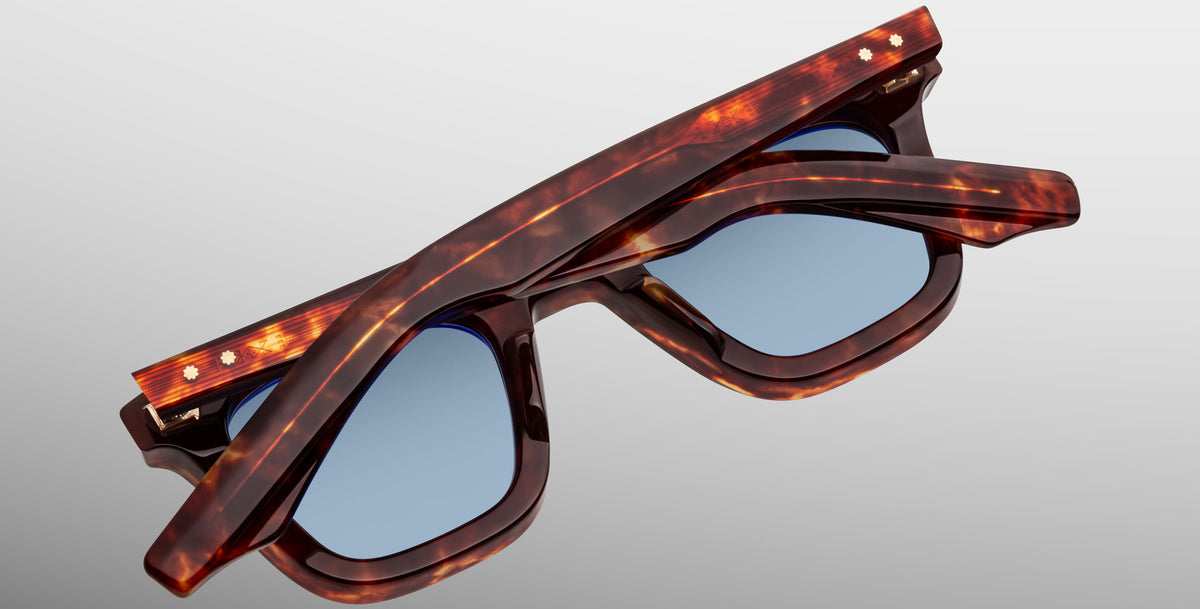 Jacques Marie Mage Leclair tortoiseshell sunglasses with blue lenses, shown folded from above on a plain, light background.