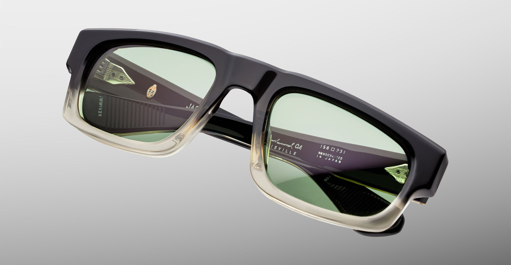 Jacques Marie Mage Louisville sunglasses with green lenses and gradient black-to-clear frames, front view.