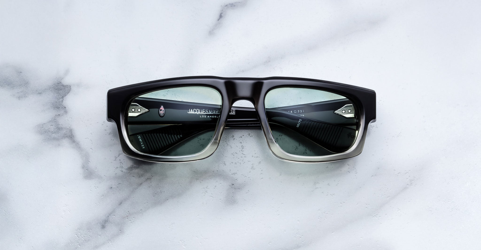 Jacques Marie Mage Louisville black sunglasses with green lenses, shown from above, featuring a bold frame design.