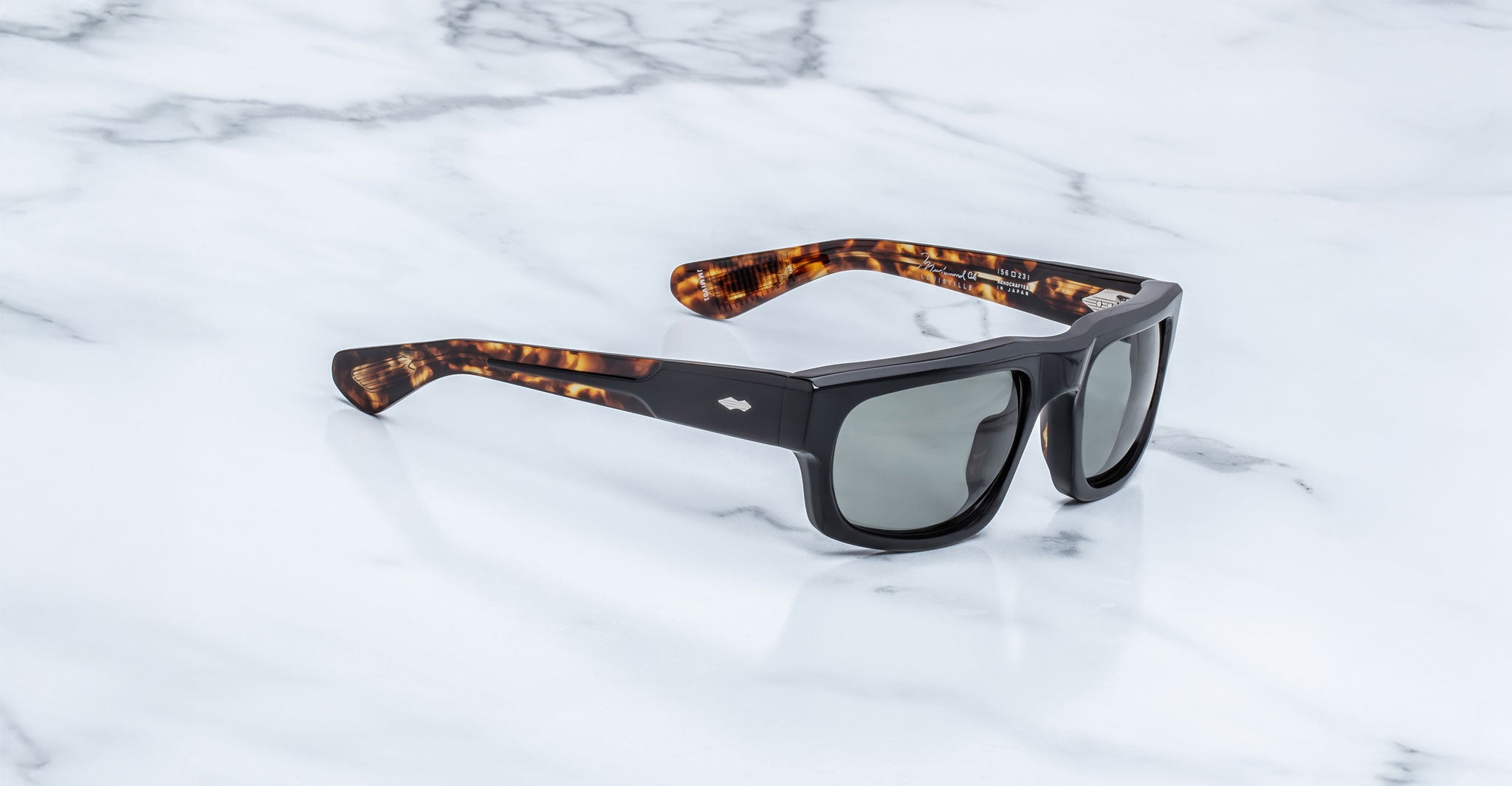 Jacques Marie Mage Louisville black polarized sunglasses with tortoiseshell arms, top view.