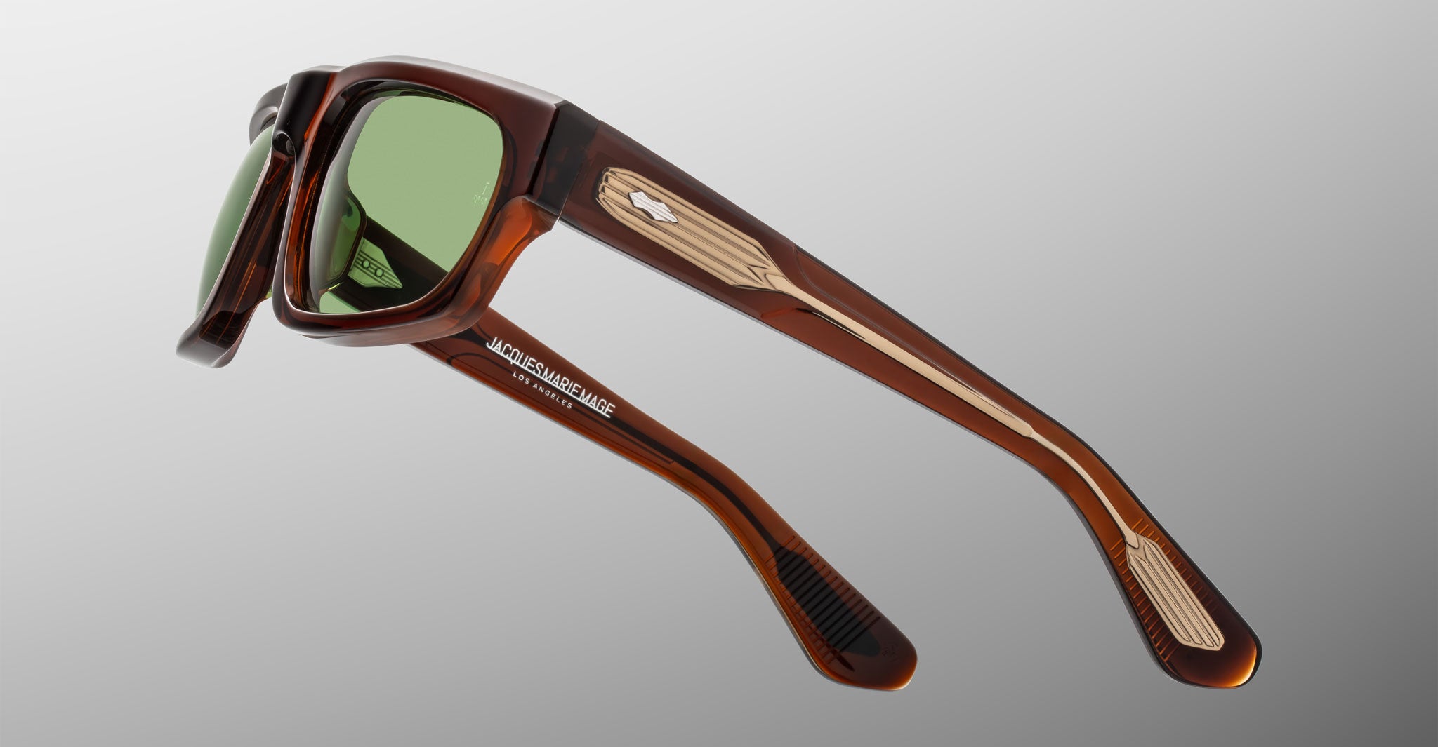 Jacques Marie Mage Louisville sunglasses shown from the front with brown acetate frame, green lenses, metallic accents, and temple logo.