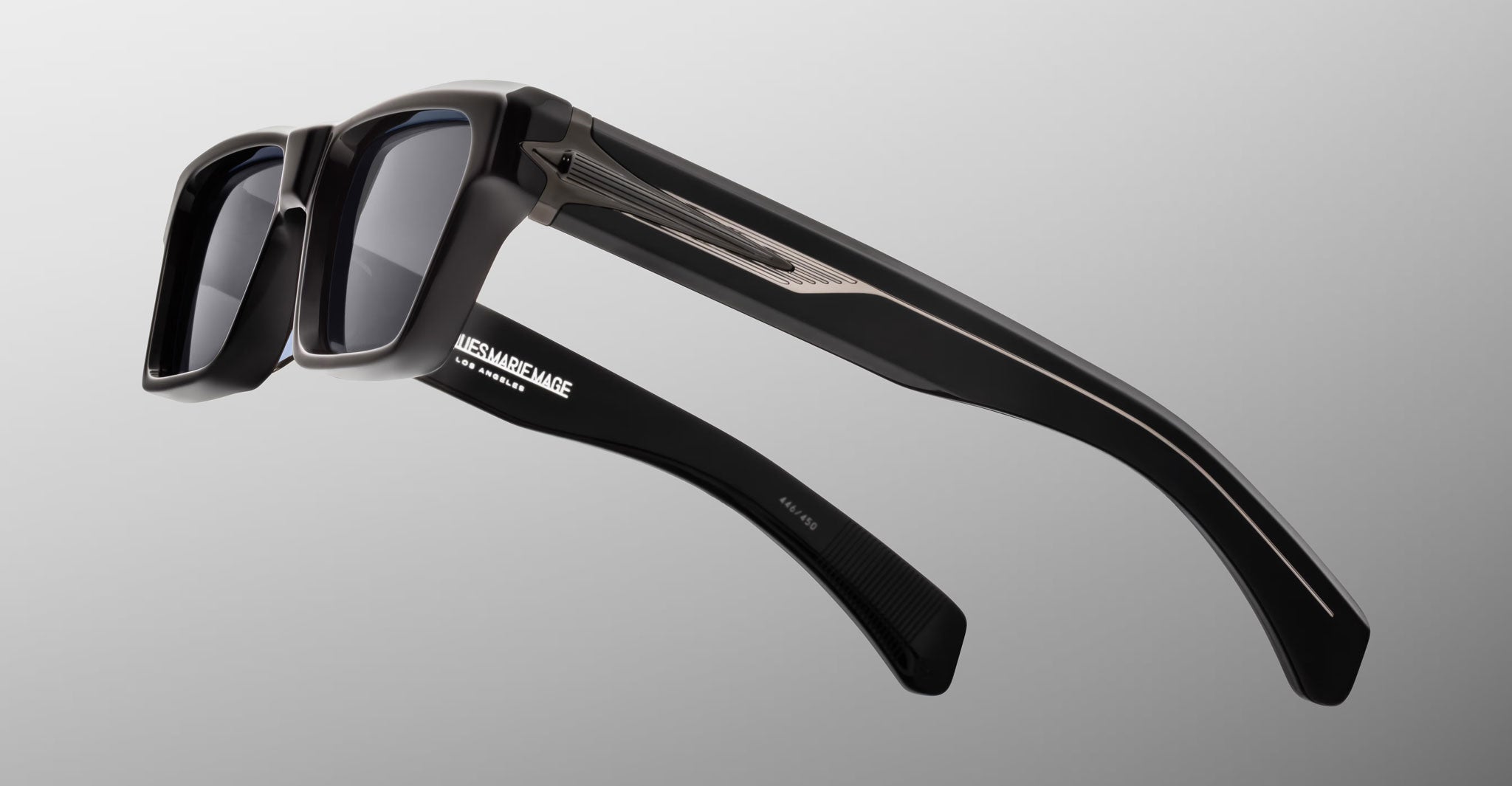 Jacques Marie Mage Melchior sunglasses, black rectangular frames with thick temples and silver accents, shown from the front angle.