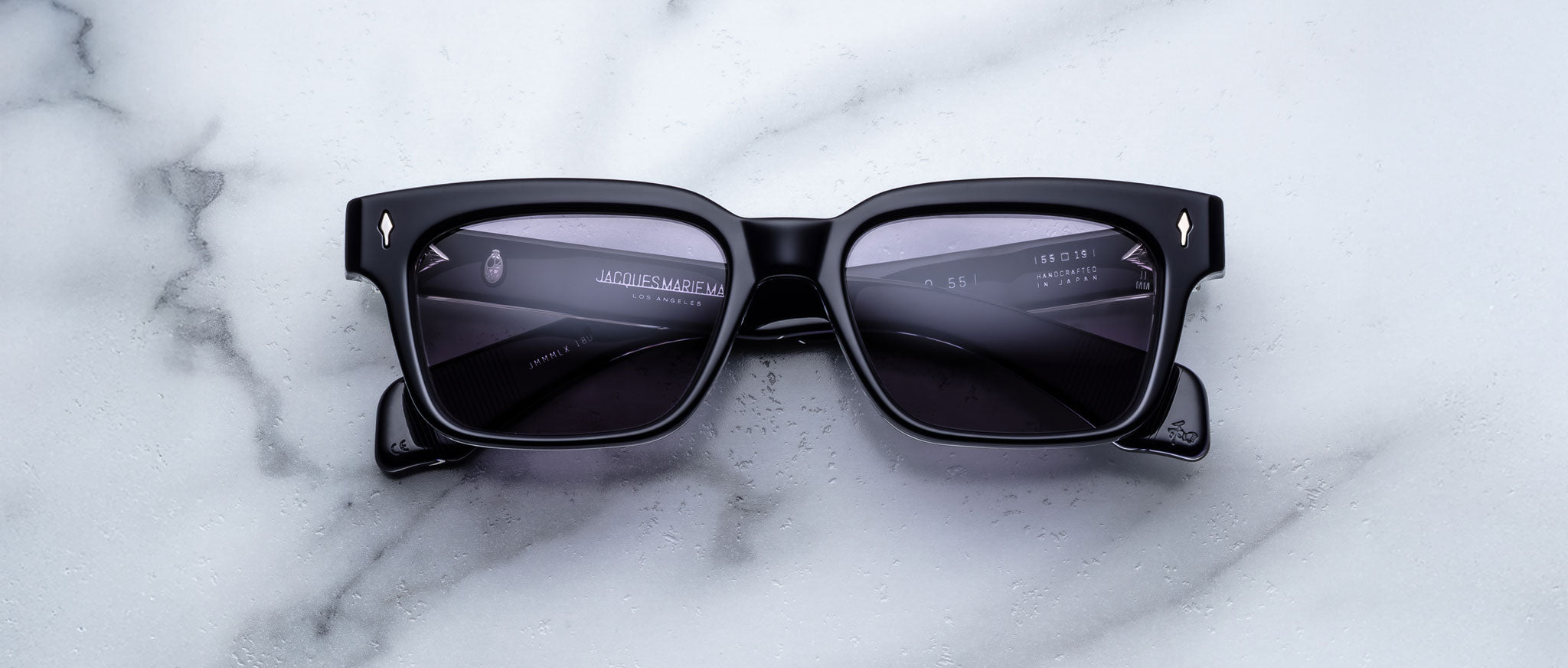 Jacques Marie Mage Molino 55 black rectangular sunglasses with dark lenses, viewed from above.