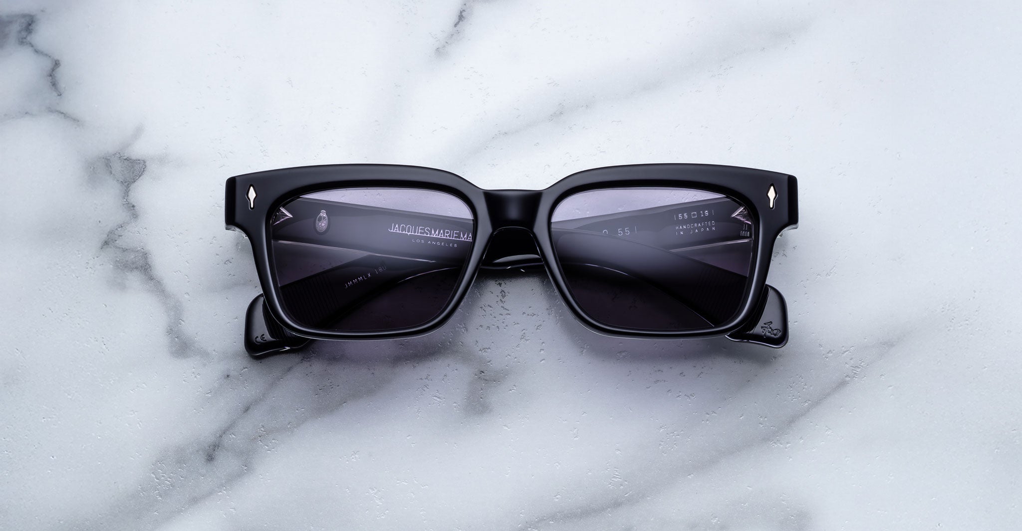 Jacques Marie Mage Molino 55 black rectangular sunglasses with dark lenses, viewed from above.