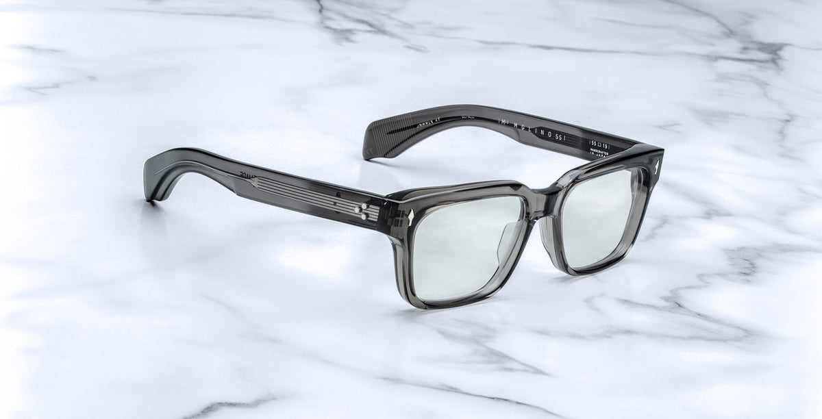 Jacques Marie Mage Molino 55 square gray eyeglasses with acetate arms, viewed from above, display on surface.