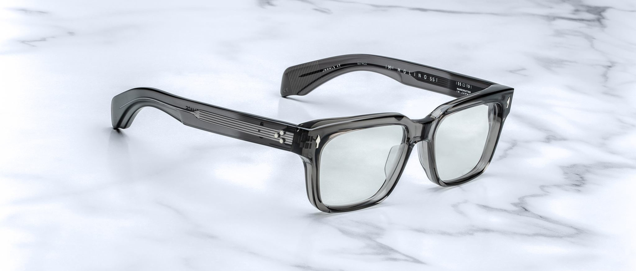 Jacques Marie Mage Molino 55 square gray eyeglasses with acetate arms, viewed from above, display on surface.