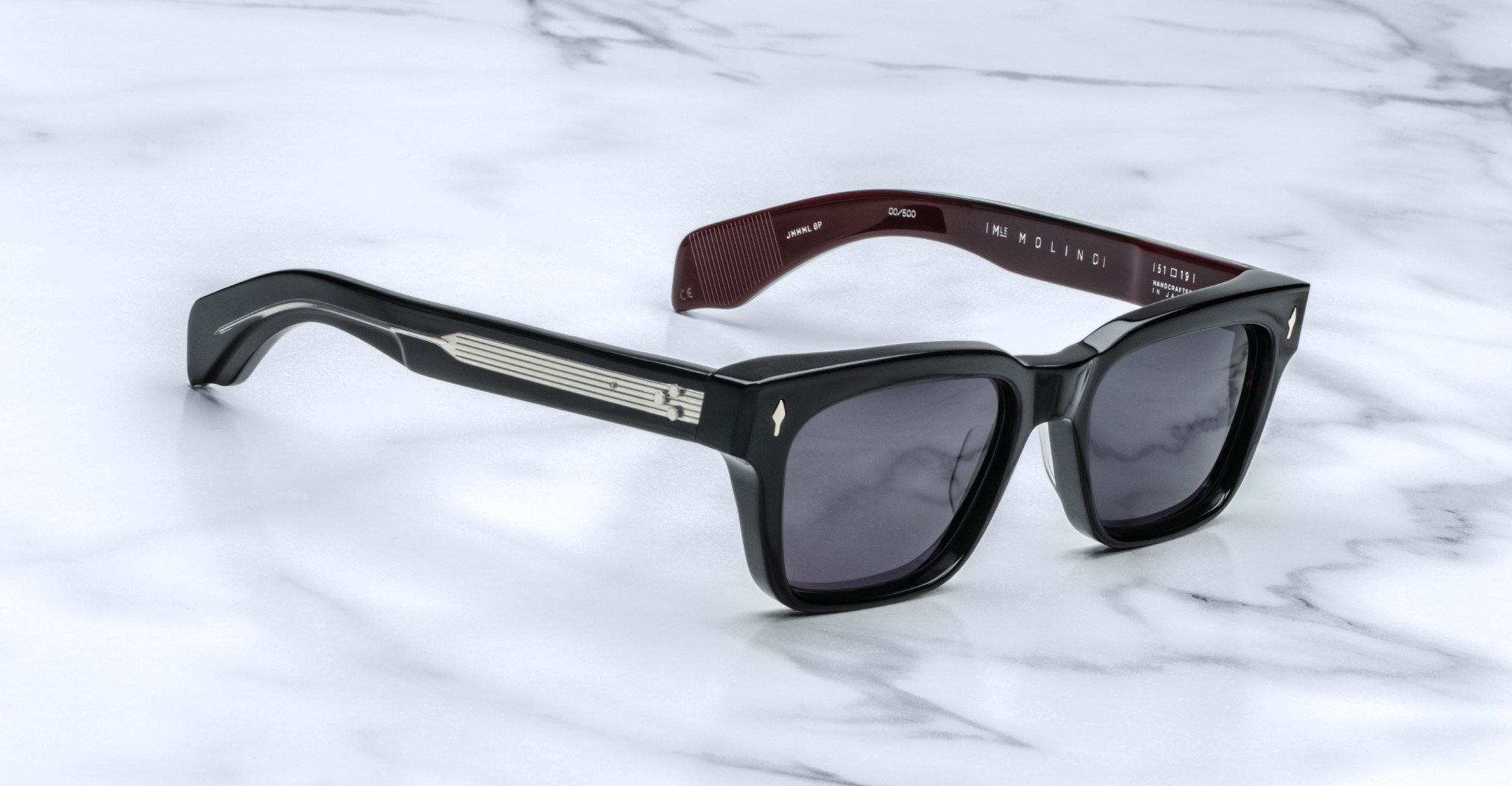 Jacques Marie Mage Molino black rectangular sunglasses with thick frames and silver accents, front view.