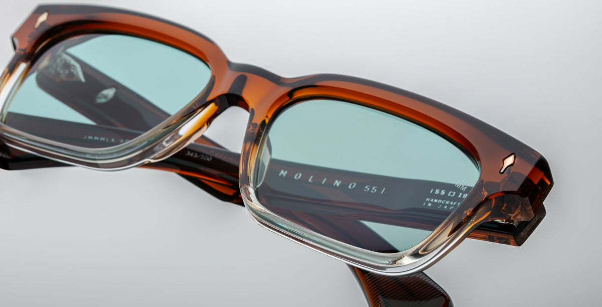 Jacques Marie Mage Molino brown rectangular eyeglasses shown close-up with light blue-tinted lenses, front view.