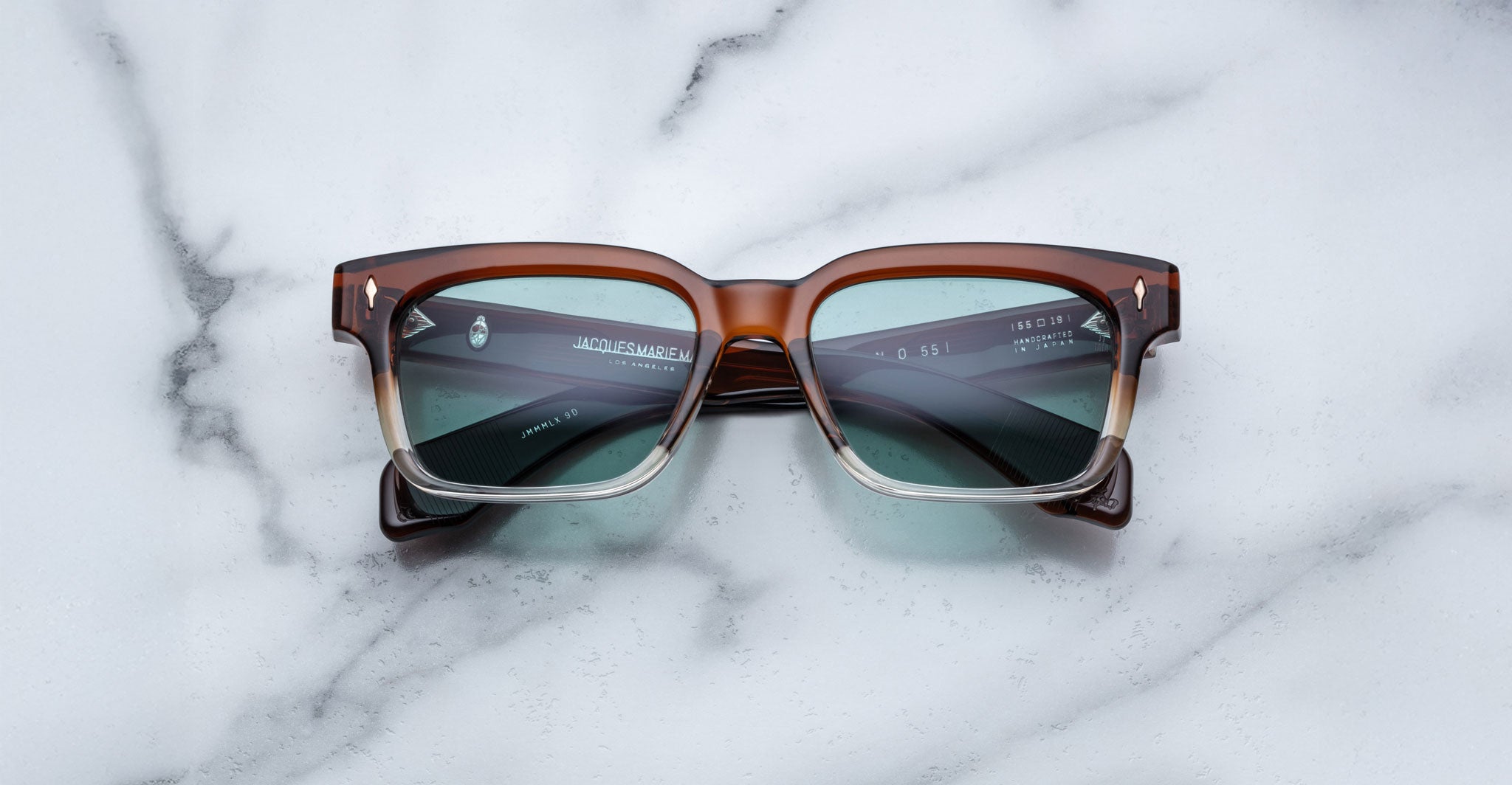 Jacques Marie Mage Molino brown rectangular sunglasses with teal UV lenses, shown from above.
