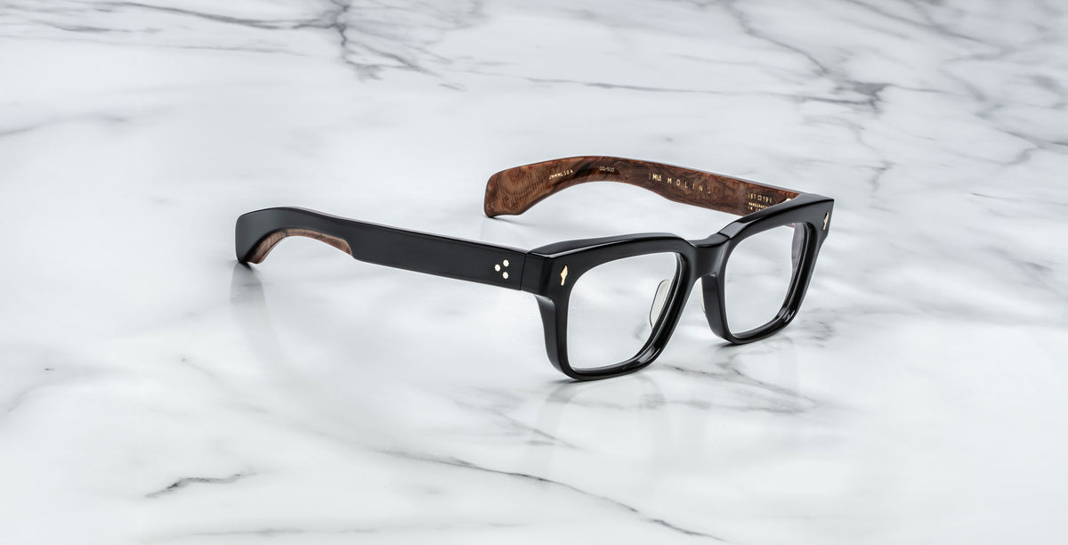 Jacques Marie Mage Molino black rectangular eyeglasses with wood-patterned temples, shown from above.