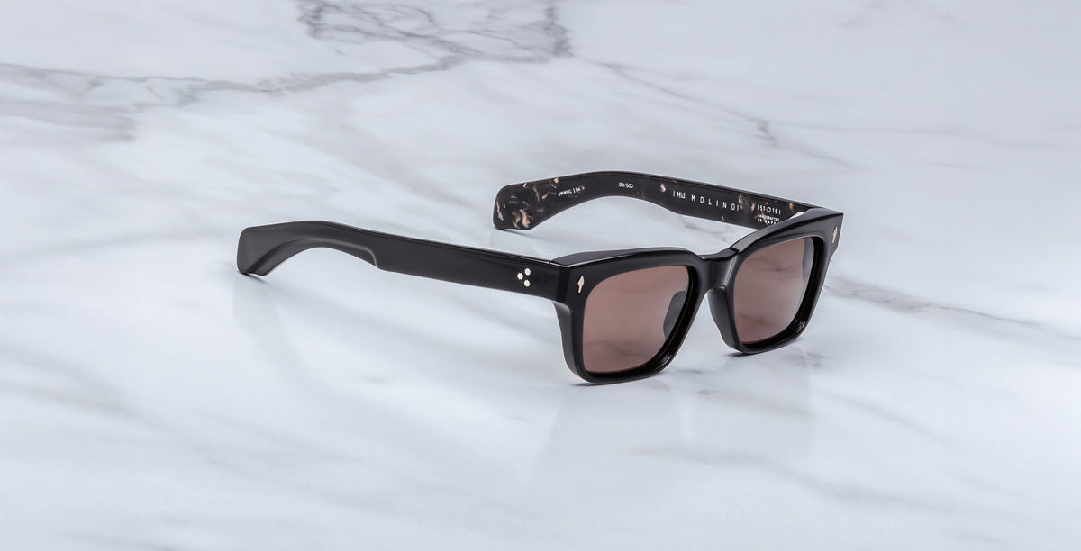 Jacques Marie Mage Molino black rectangular sunglasses with UV-protective lenses, shown from above.