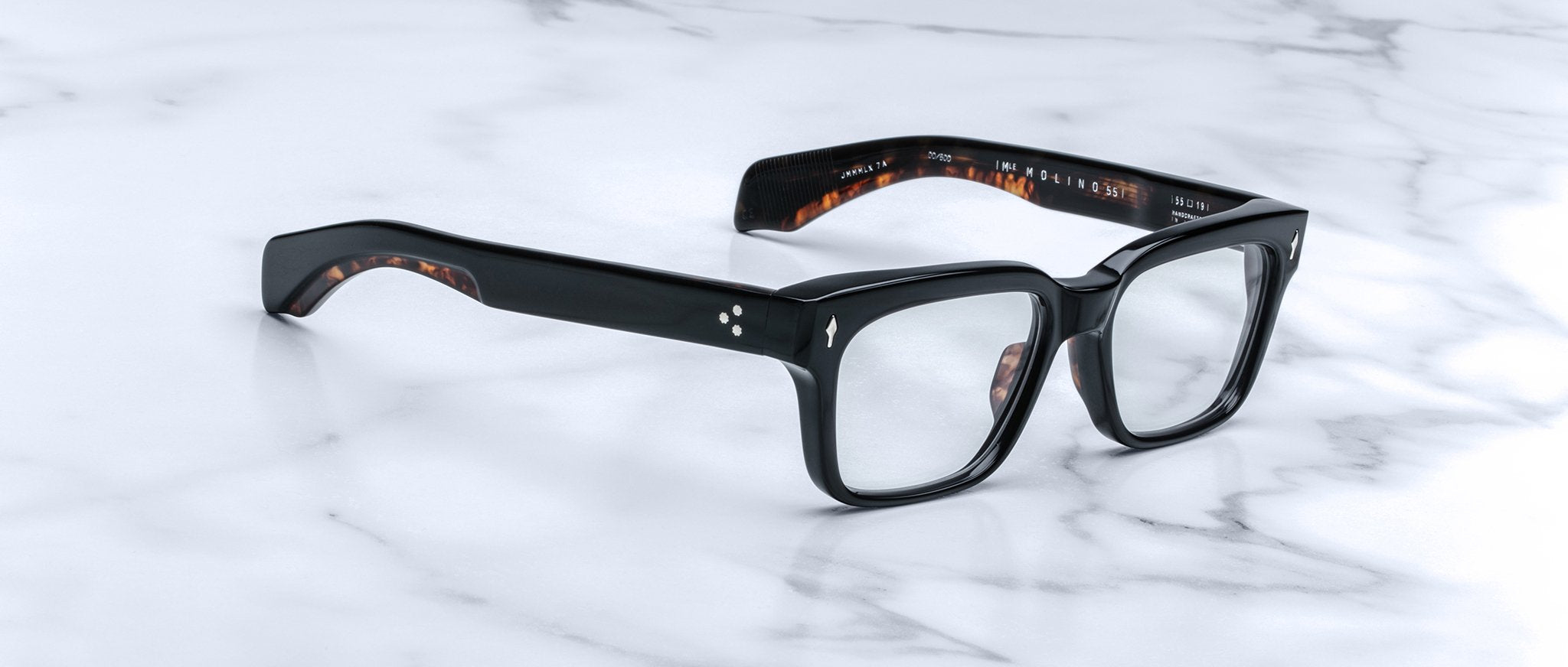 Jacques Marie Mage Molino 55 eyeglasses, black rectangular frame with tortoiseshell arms, shown from above.