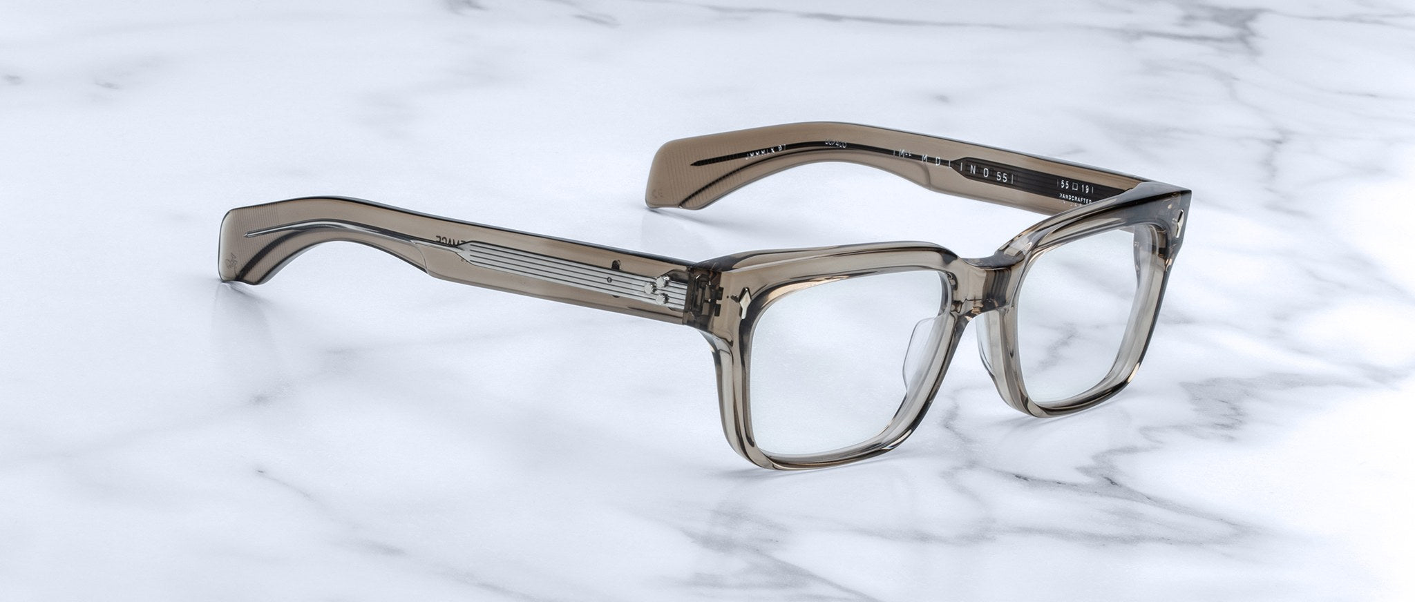 Jacques Marie Mage Molino 55 thick-rimmed rectangular eyeglasses, front view, displayed on a marble surface.