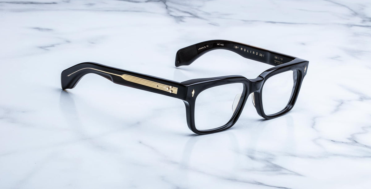 Jacques Marie Mage Molino 55 eyeglasses shown from the front with black rectangular frames and gold temple accents.