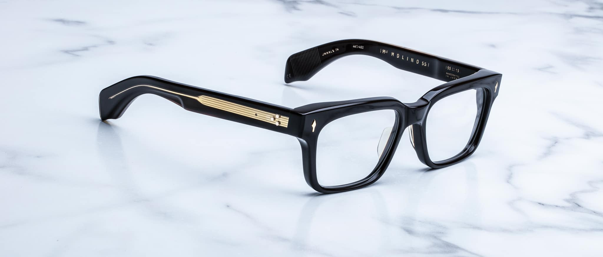 Jacques Marie Mage Molino 55 eyeglasses shown from the front with black rectangular frames and gold temple accents.