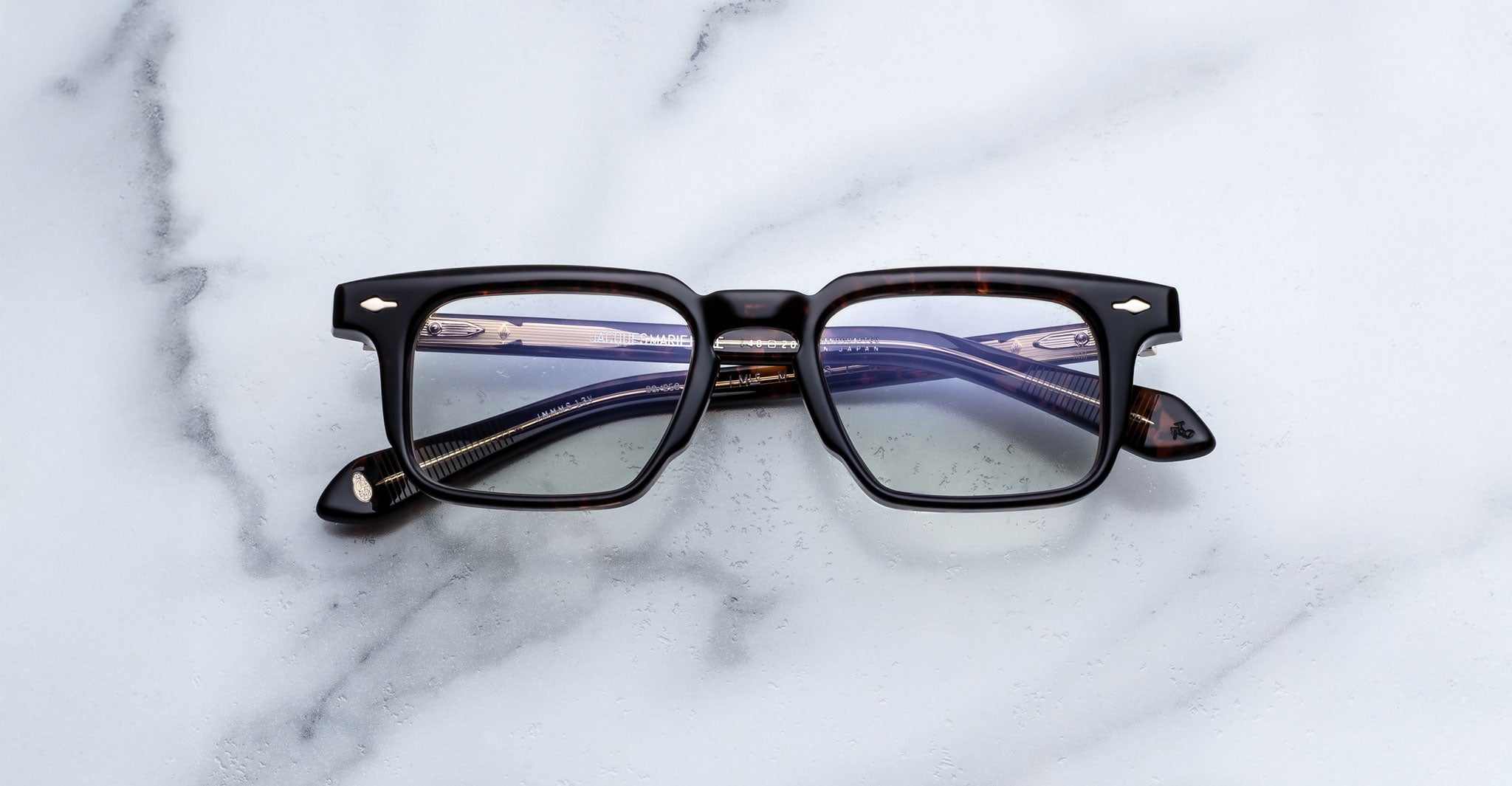 Jacques Marie Mage Moscova in Beau acetate optical frame, front-facing view with rectangular lenses, rich tortoiseshell acetate, signature arrowhead pins, and visible core wire temples with warm tonal detailing