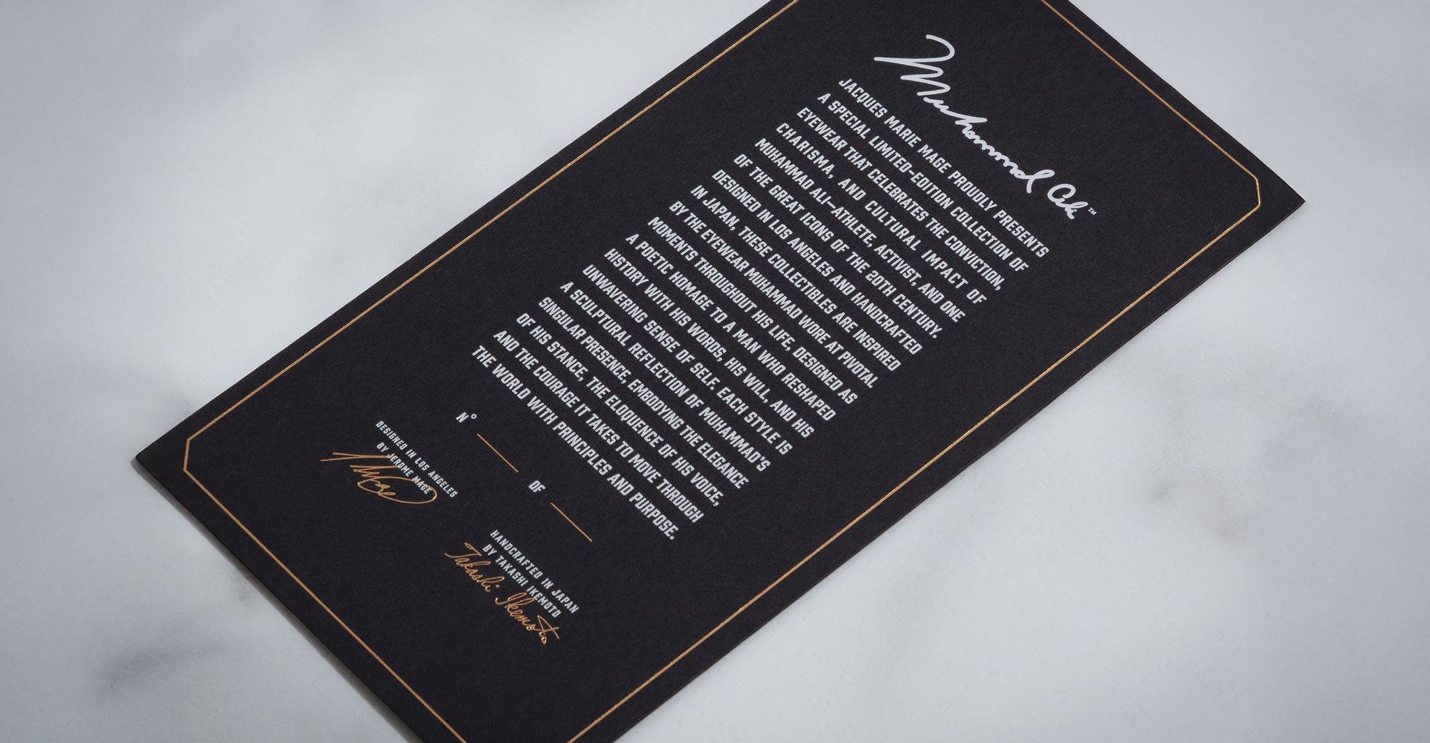 Jacques Marie Mage Kinshasa eyeglasses card, black with gold borders, shows two signatures and bold script at the top.