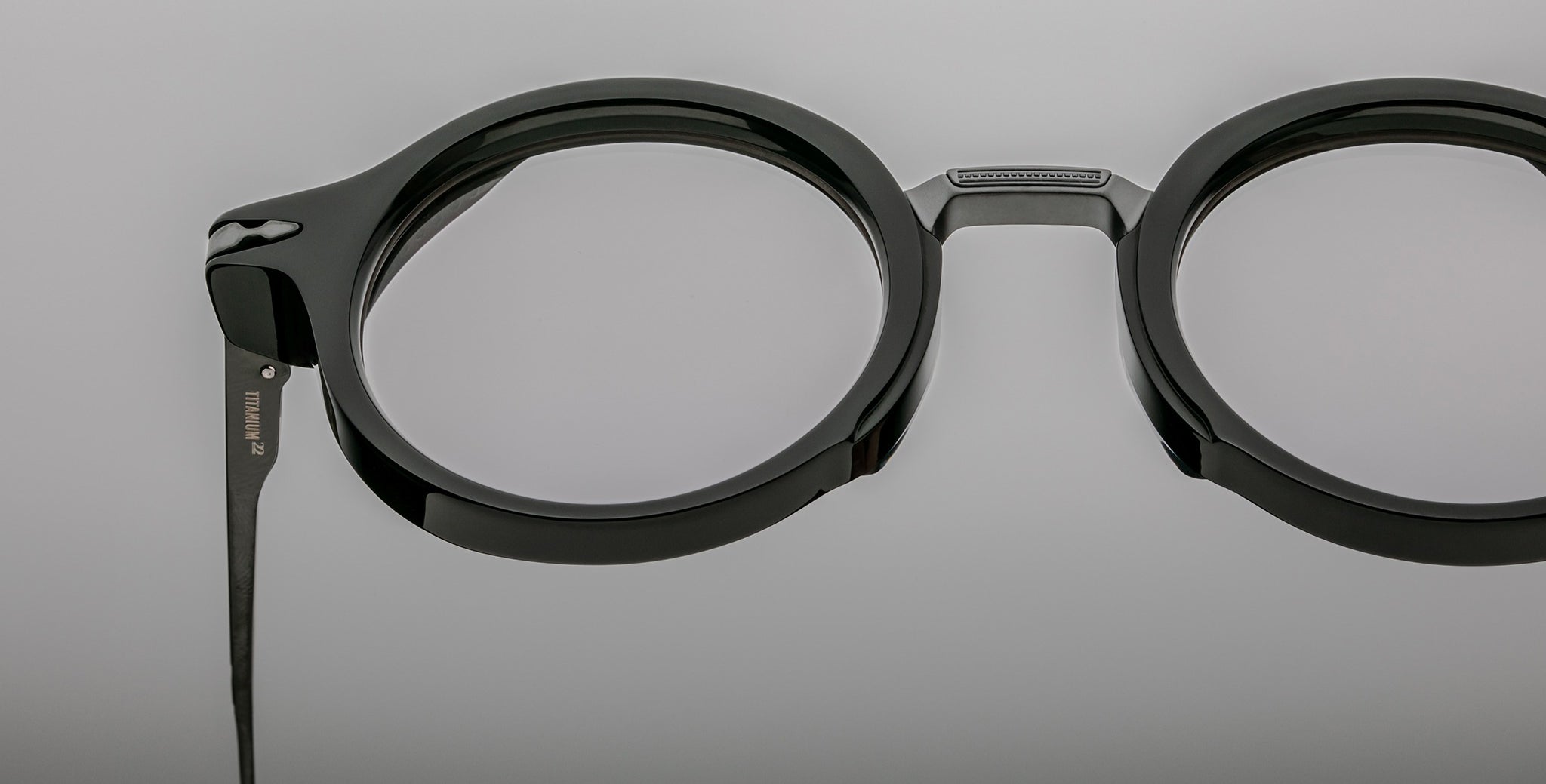 Close-up of Jacques Marie Mage Norman black round eyeglasses with clear lenses, showing the front and side profile.