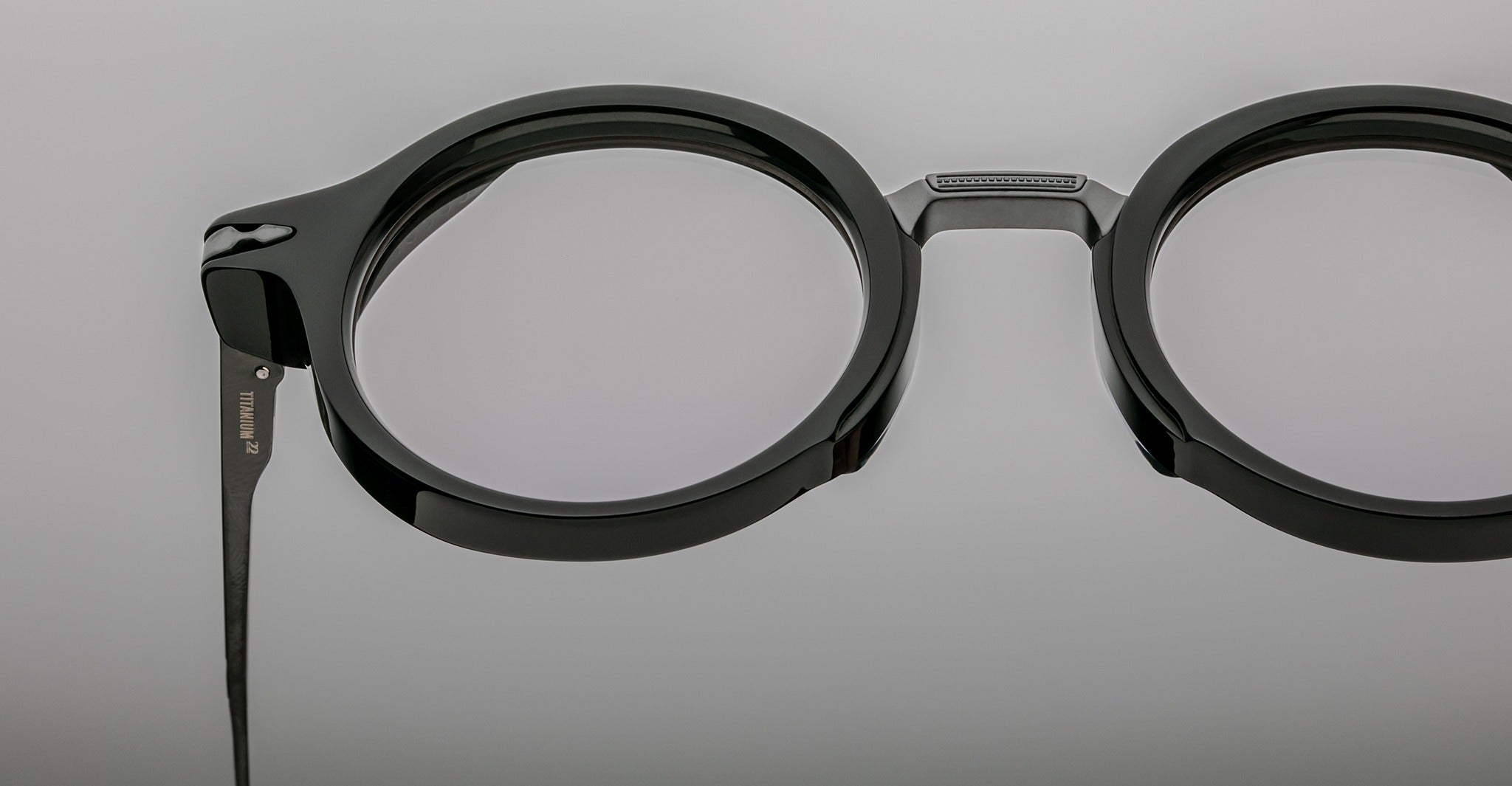 Close-up of Jacques Marie Mage Norman black round eyeglasses with clear lenses, showing the front and side profile.