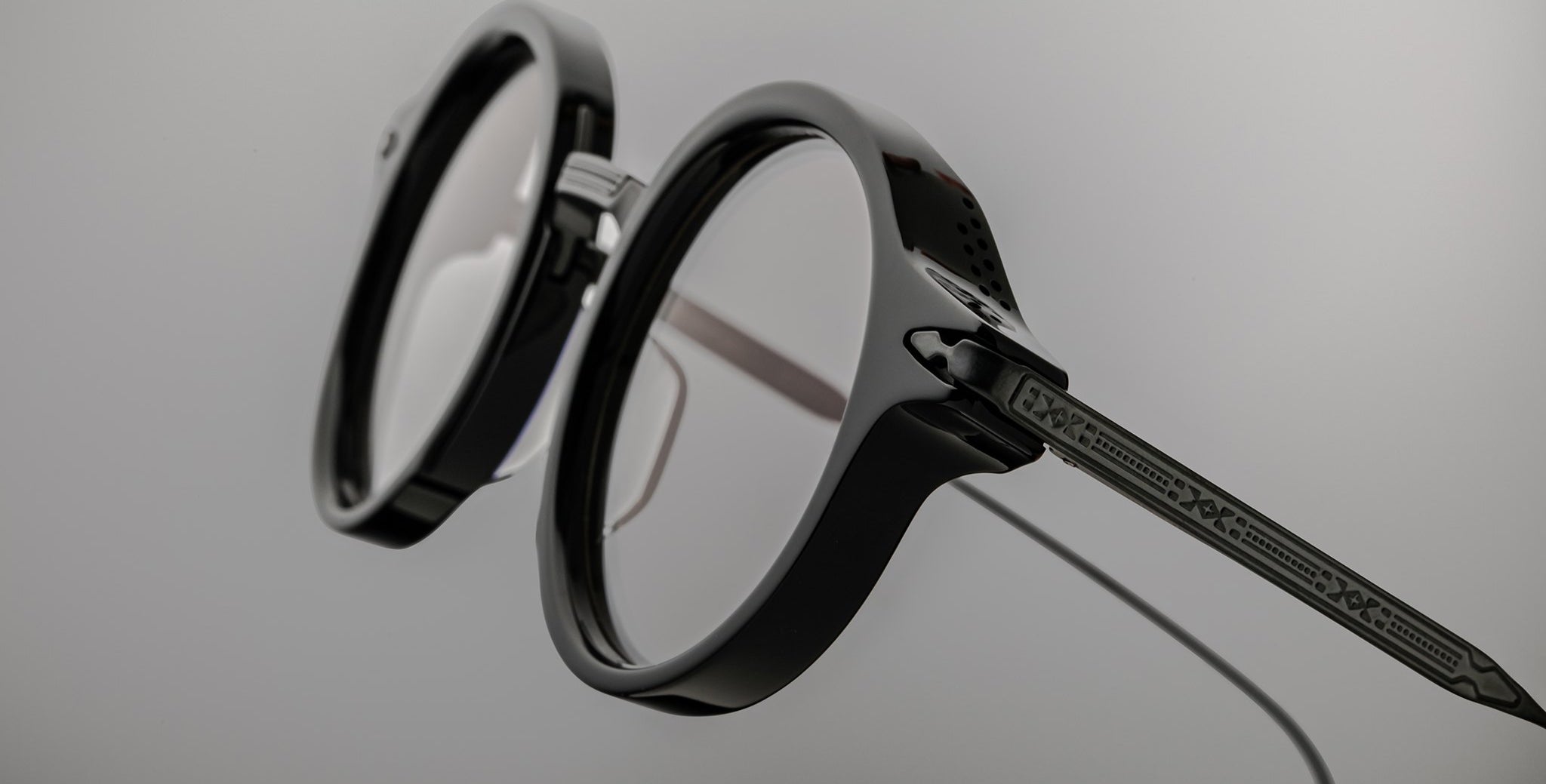 Close-up of Jacques Marie Mage Norman black round eyeglasses with clear lenses, front view.