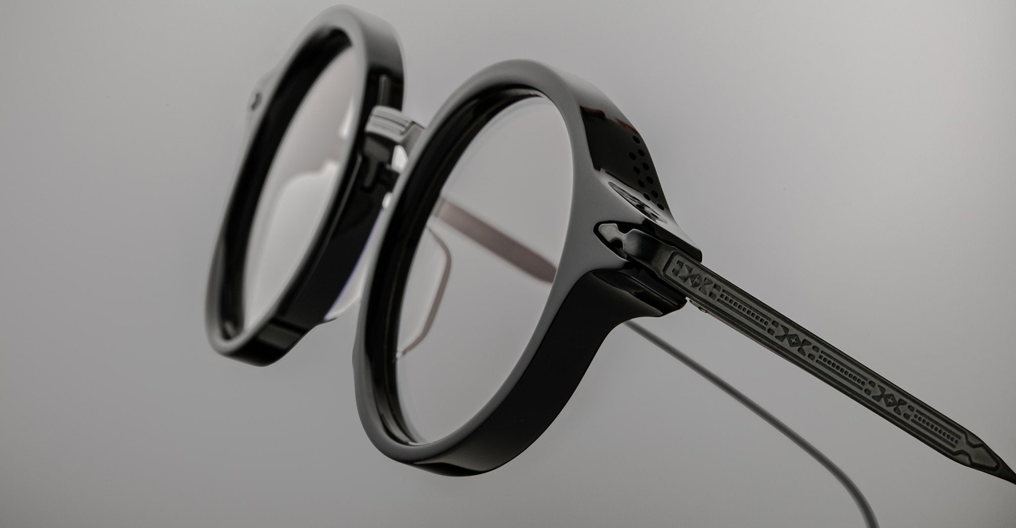 Close-up of Jacques Marie Mage Norman black round eyeglasses with clear lenses, front view.