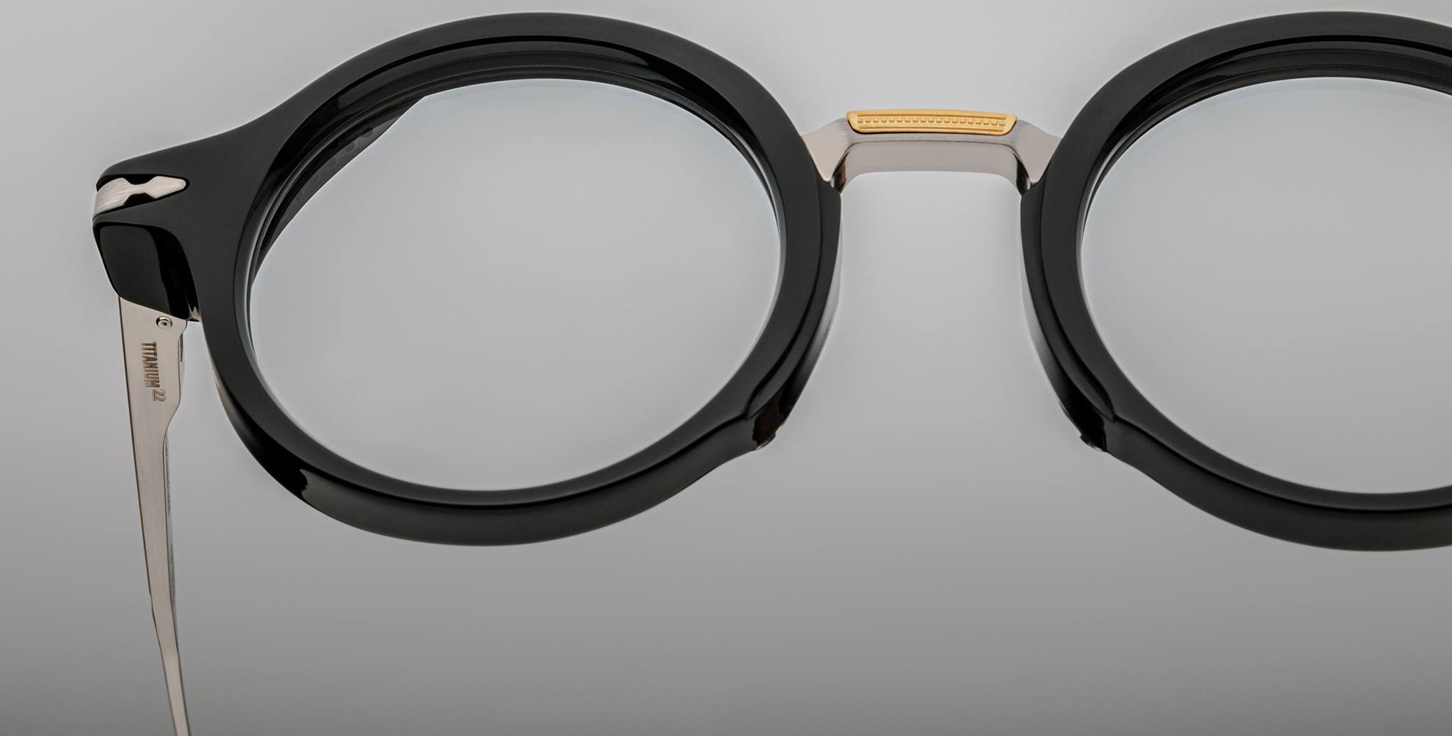 Close-up of Jacques Marie Mage Norman black round eyeglasses, featuring metal bridge and temples, viewed from the front.