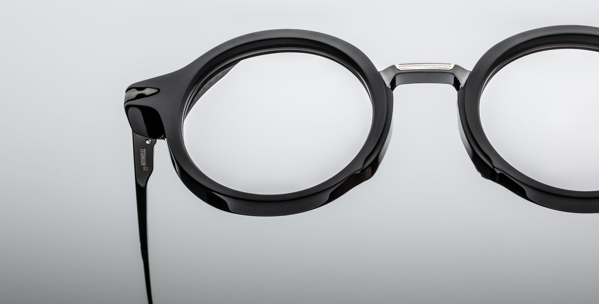 Close-up of Jacques Marie Mage Norman black round eyeglasses with thick frames, viewed from the front.