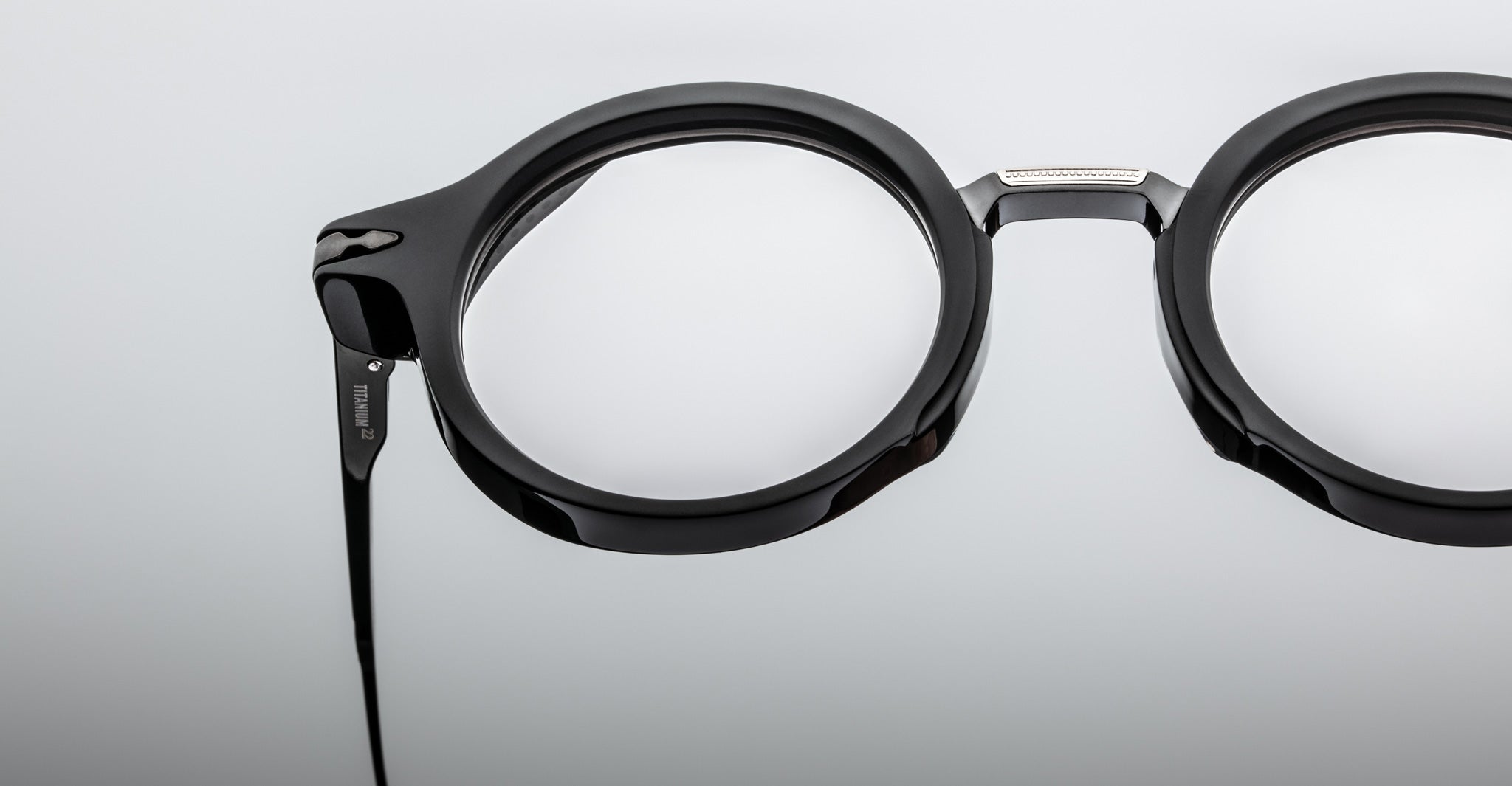 Close-up of Jacques Marie Mage Norman black round eyeglasses with thick frames, viewed from the front.