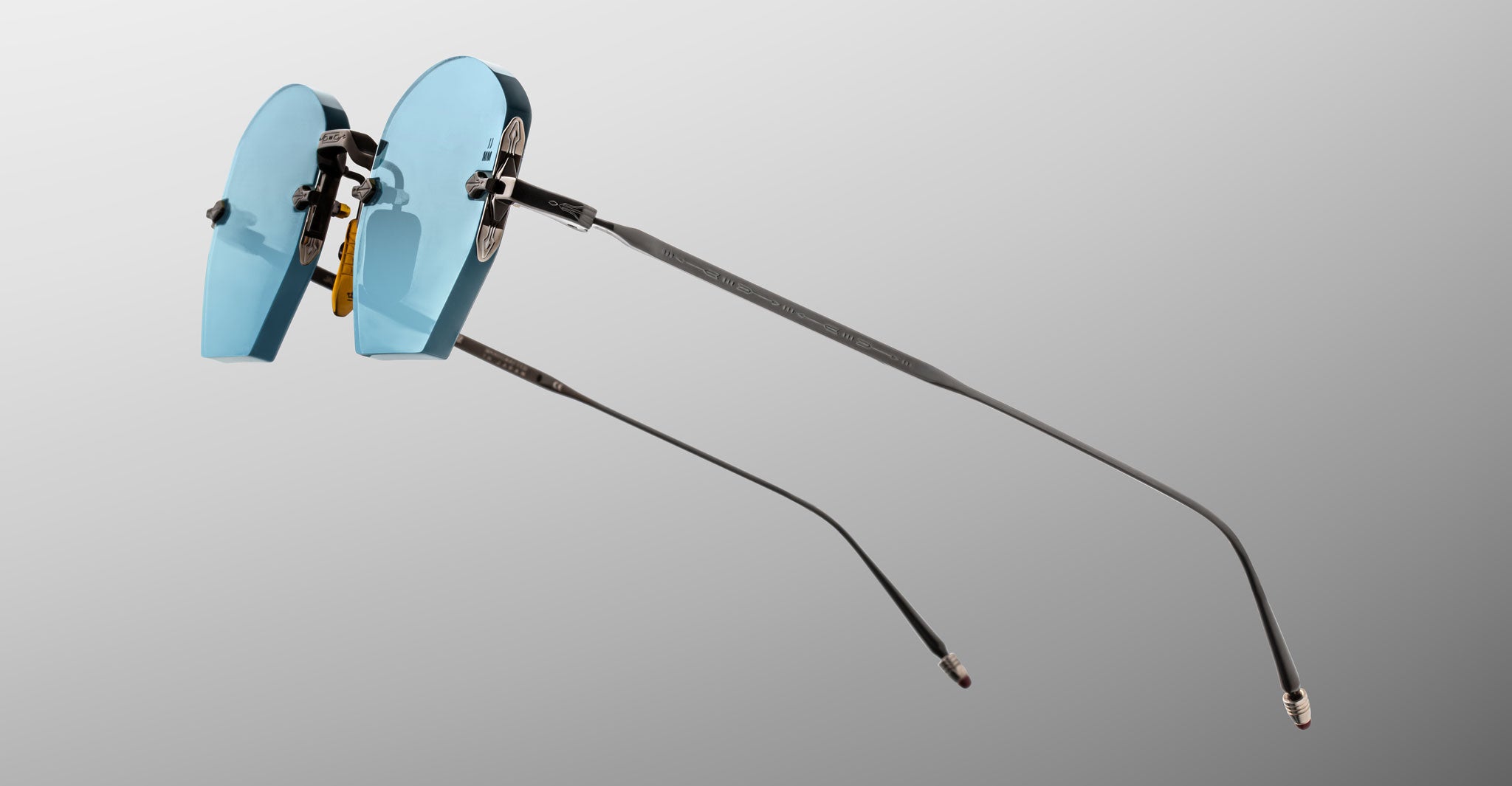 Jacques Marie Mage Oatman in Lagoon rimless sunglasses with UV-protected blue-tinted lenses and thin metal arms, side view.