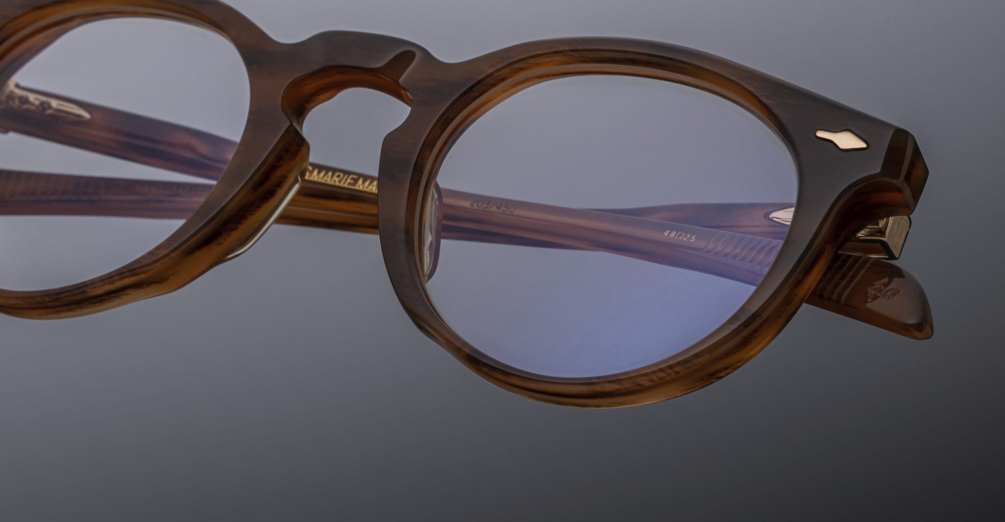 Close-up of Jacques Marie Mage Percier brown round eyeglasses with clear lenses, front angle.
