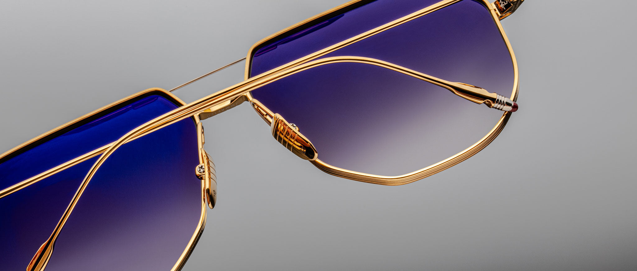 Jacques Marie Mage Reynold sunglasses with gold frames and blue gradient lenses, shown from the front.