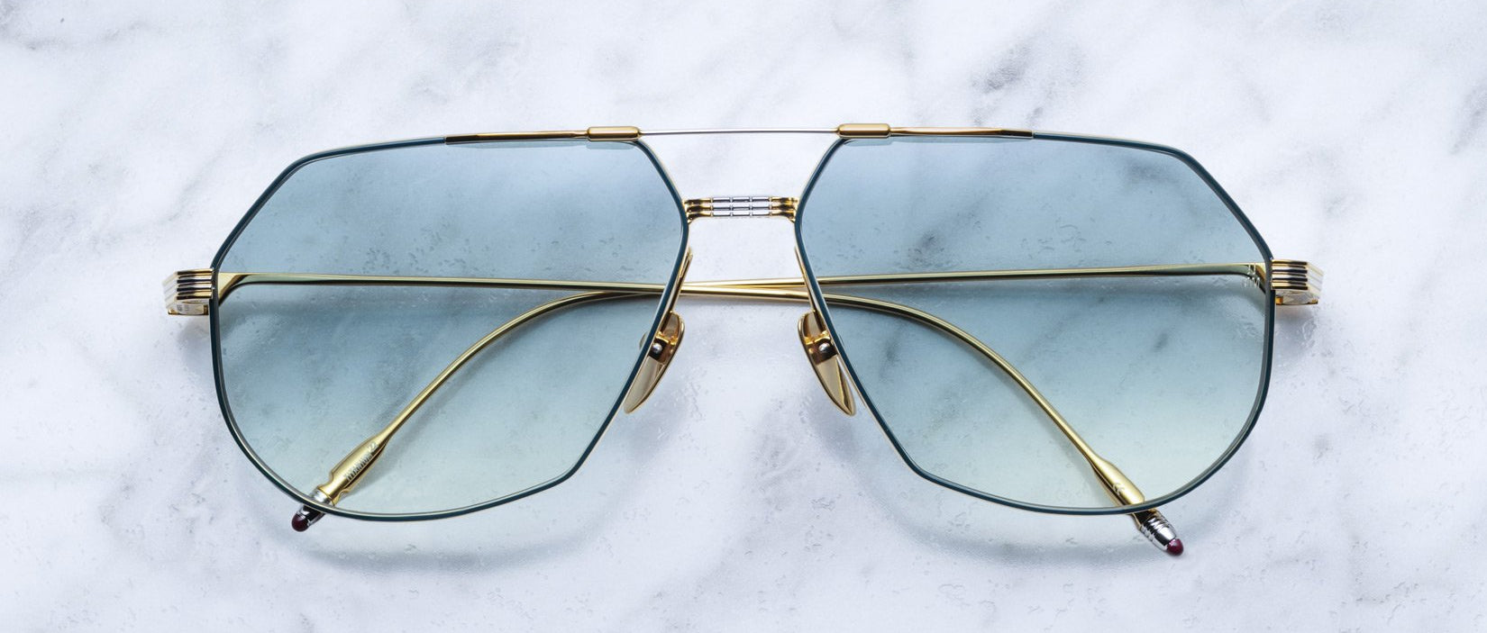 Jacques Marie Mage Reynold gold aviator sunglasses with light blue lenses, front view.