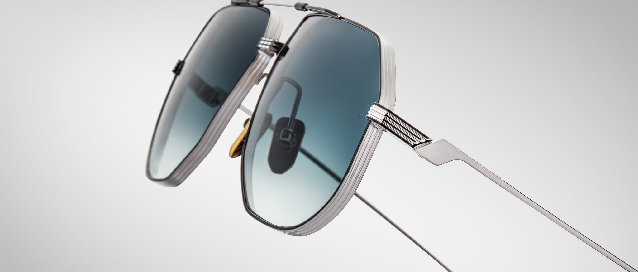 Close-up of Jacques Marie Mage Reynold silver sunglasses with blue gradient lenses, front view.