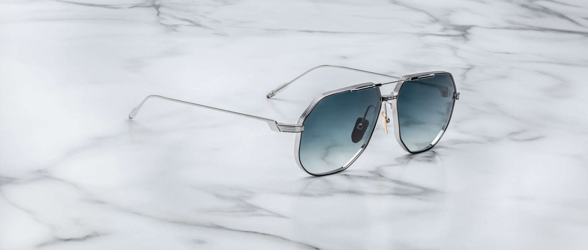 Jacques Marie Mage Reynold silver aviator sunglasses with blue lenses, front angled view.