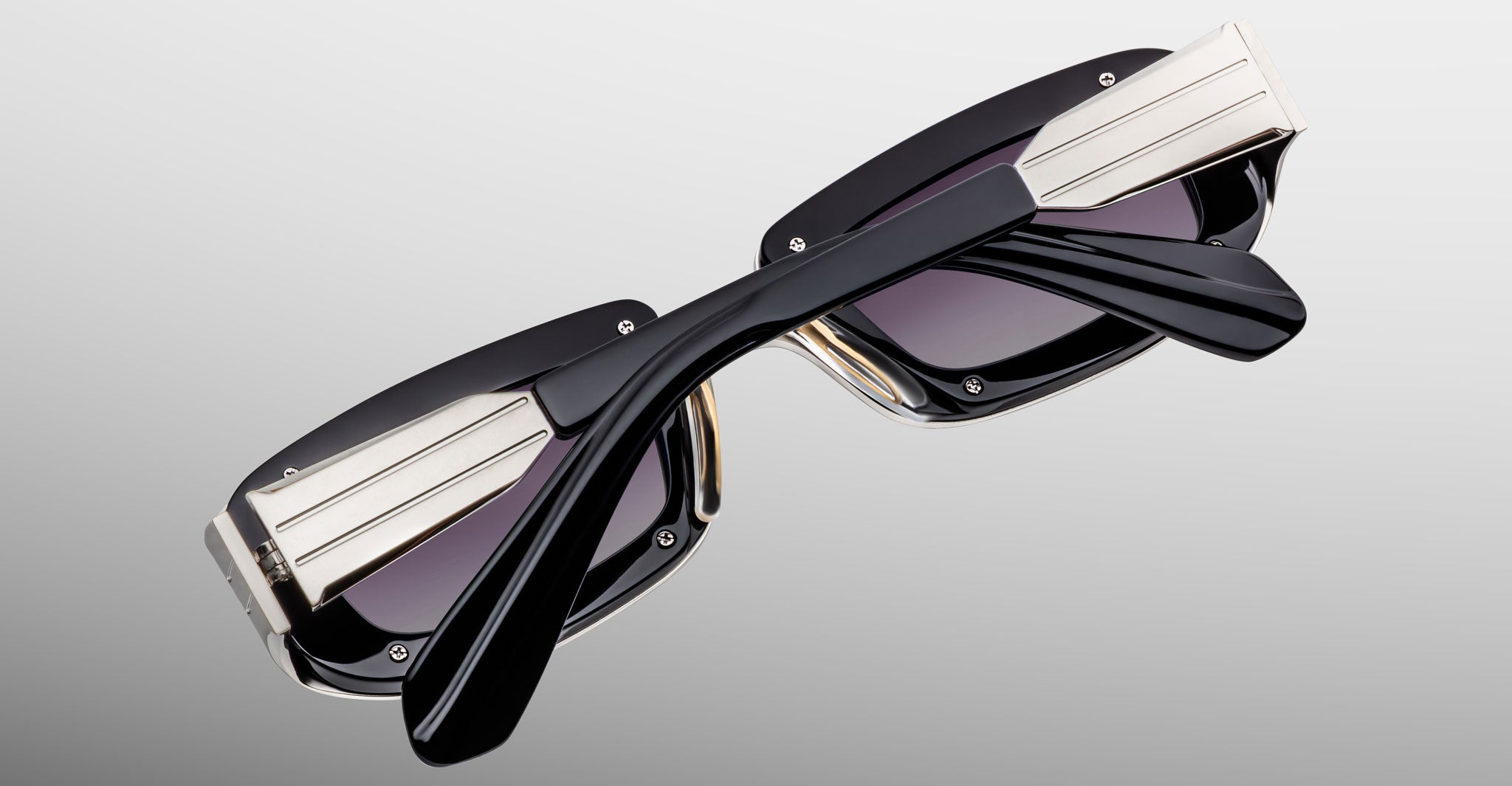 Jacques Marie Mage Ryder in Silver, rectangular silver-tone acetate sunglasses shown from an angled top view, highlighting thick sculpted rims, wide temples with stepped detailing, and gradient tinted lenses.