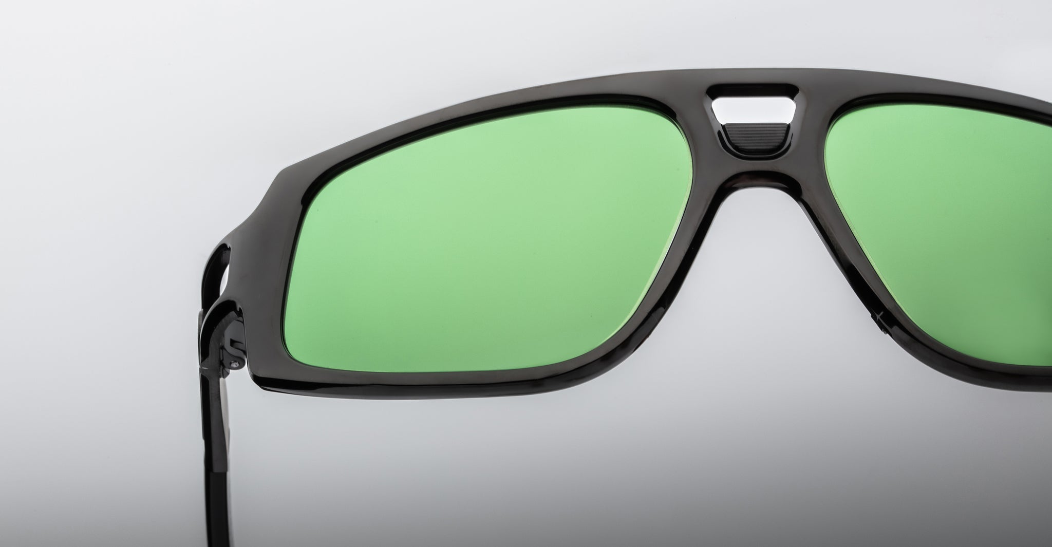 Close-up of Jacques Marie Mage Scarface sunglasses with green lenses, front view.