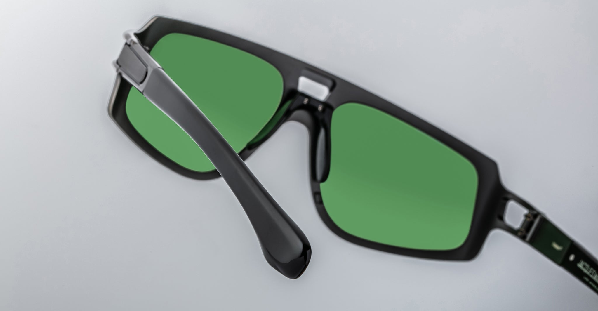 Jacques Marie Mage Scarface sunglasses with green lenses, close-up view, showcasing the frame and lens details.