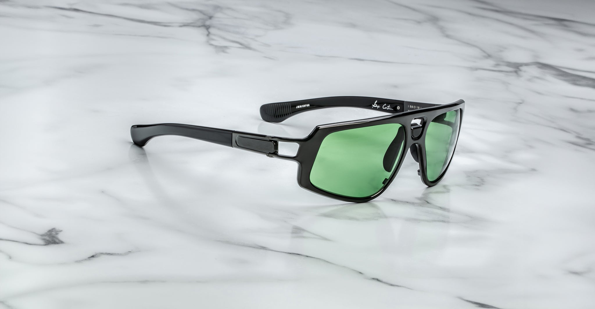 Jacques Marie Mage Scarface sunglasses with black frames and green lenses, shown from above.