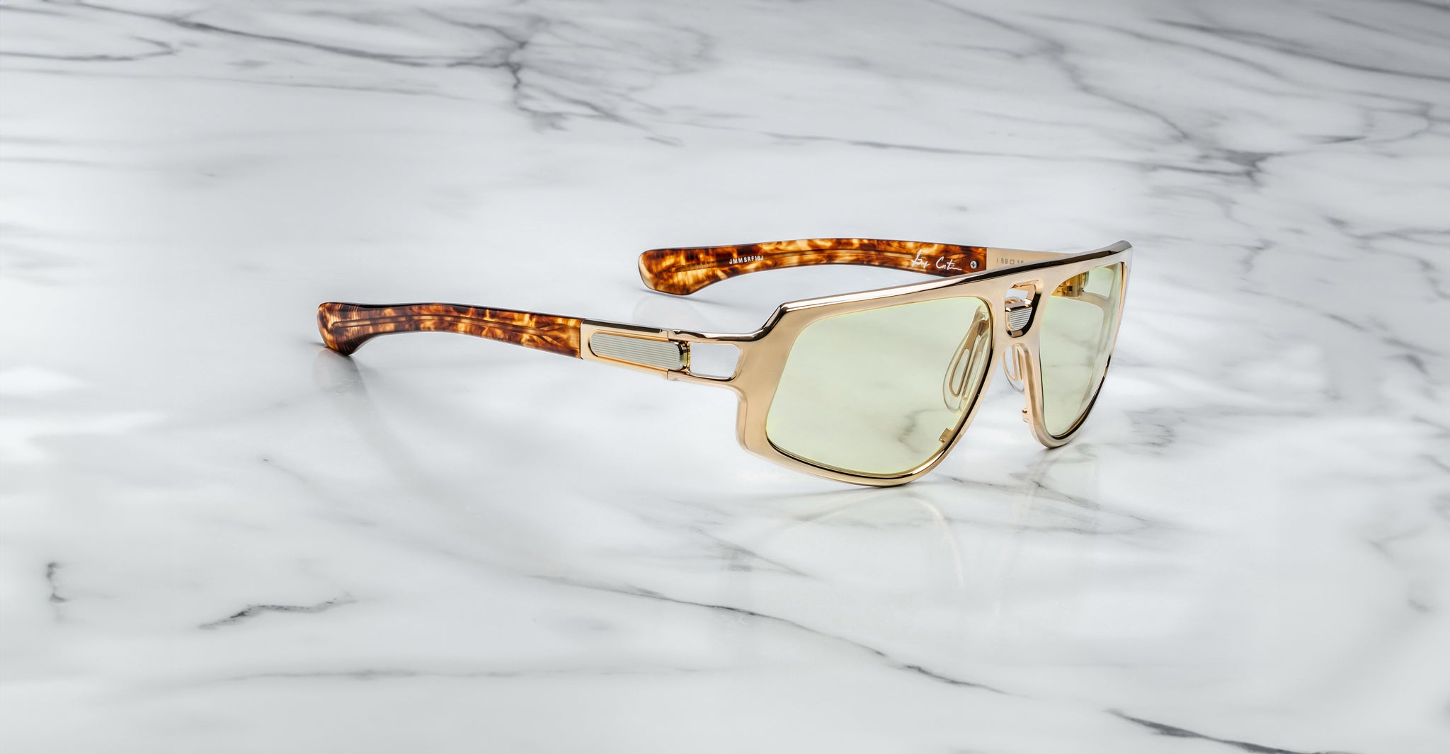 Jacques Marie Mage Scarface sunglasses in gold with tortoiseshell arms and light lenses, shown from above.