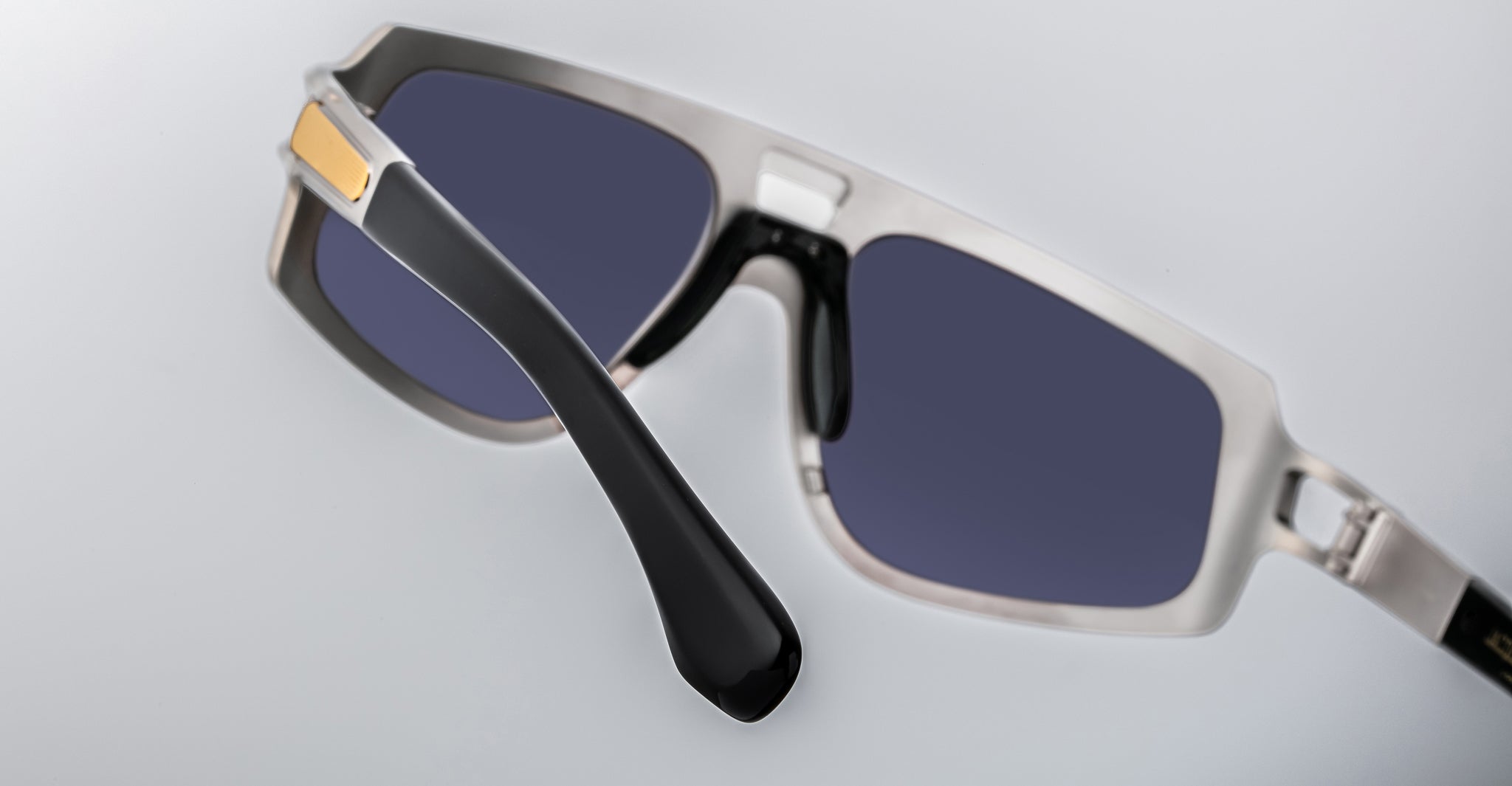 Close-up of Jacques Marie Mage Scarface sunglasses, featuring dark UV lenses and thick black and silver frames, front view.