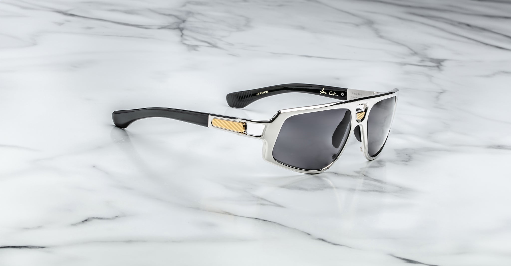 Jacques Marie Mage Scarface sunglasses in silver and black with polarized dark lenses, top view.