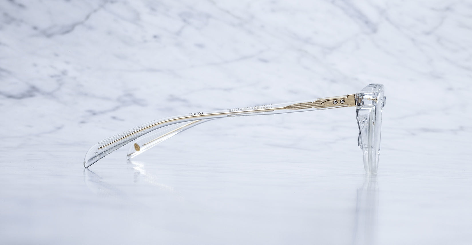 Jacques Marie Mage Sheridan in Clear, crystal acetate glasses with visible wirecore temples and gold hardware, side view