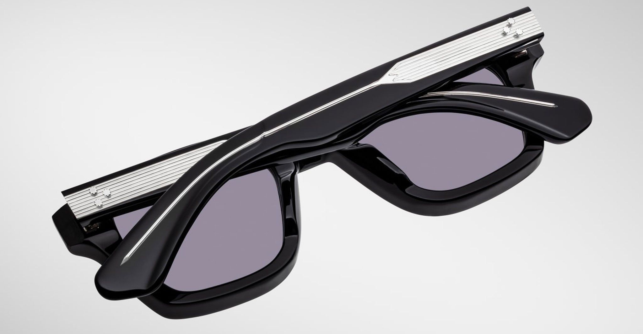 Jacques Marie Mage Sonata black sunglasses with silver accents, folded, shown from above.