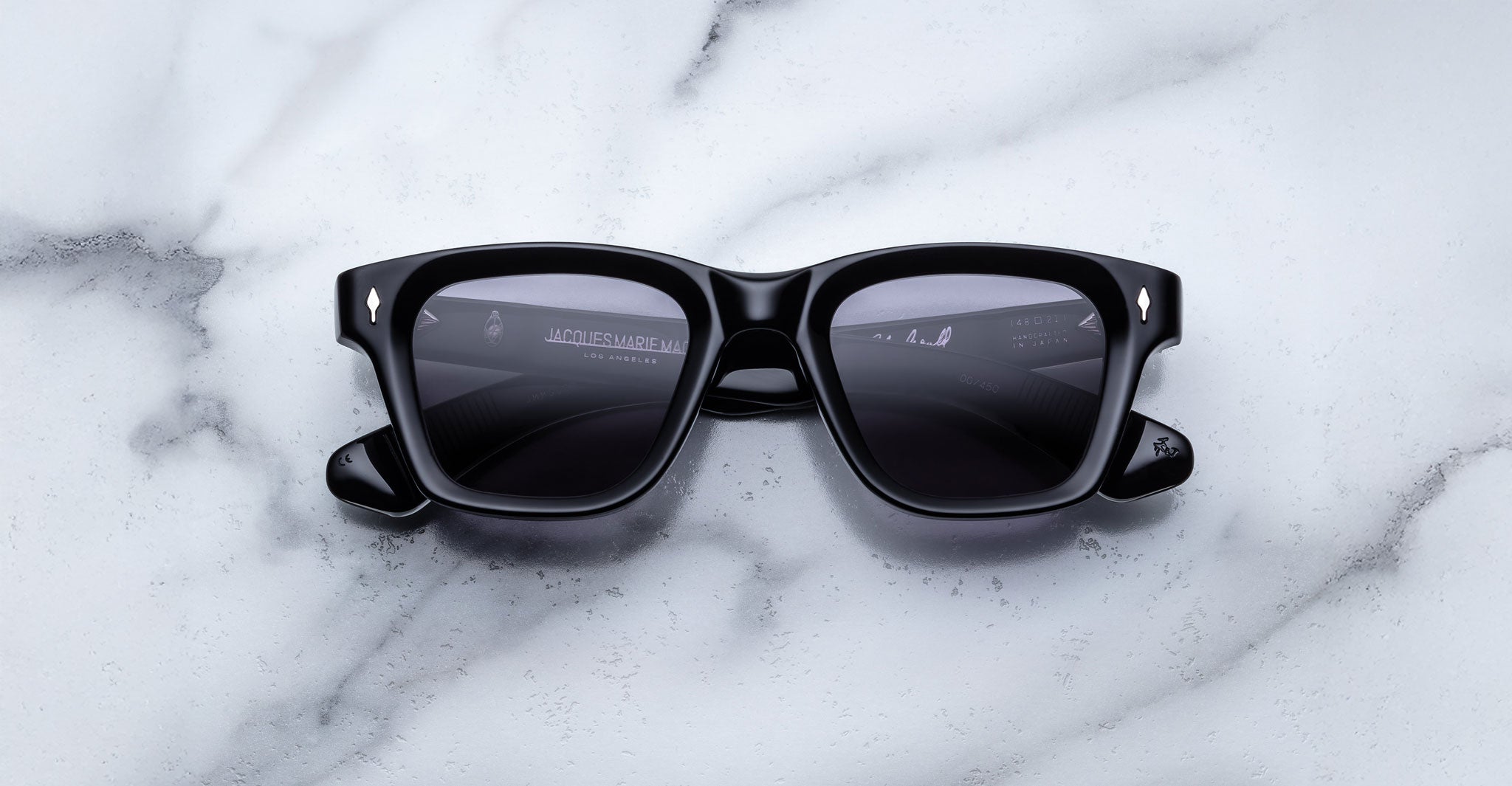 Jacques Marie Mage Sonata black rectangular sunglasses with dark lenses, top view.