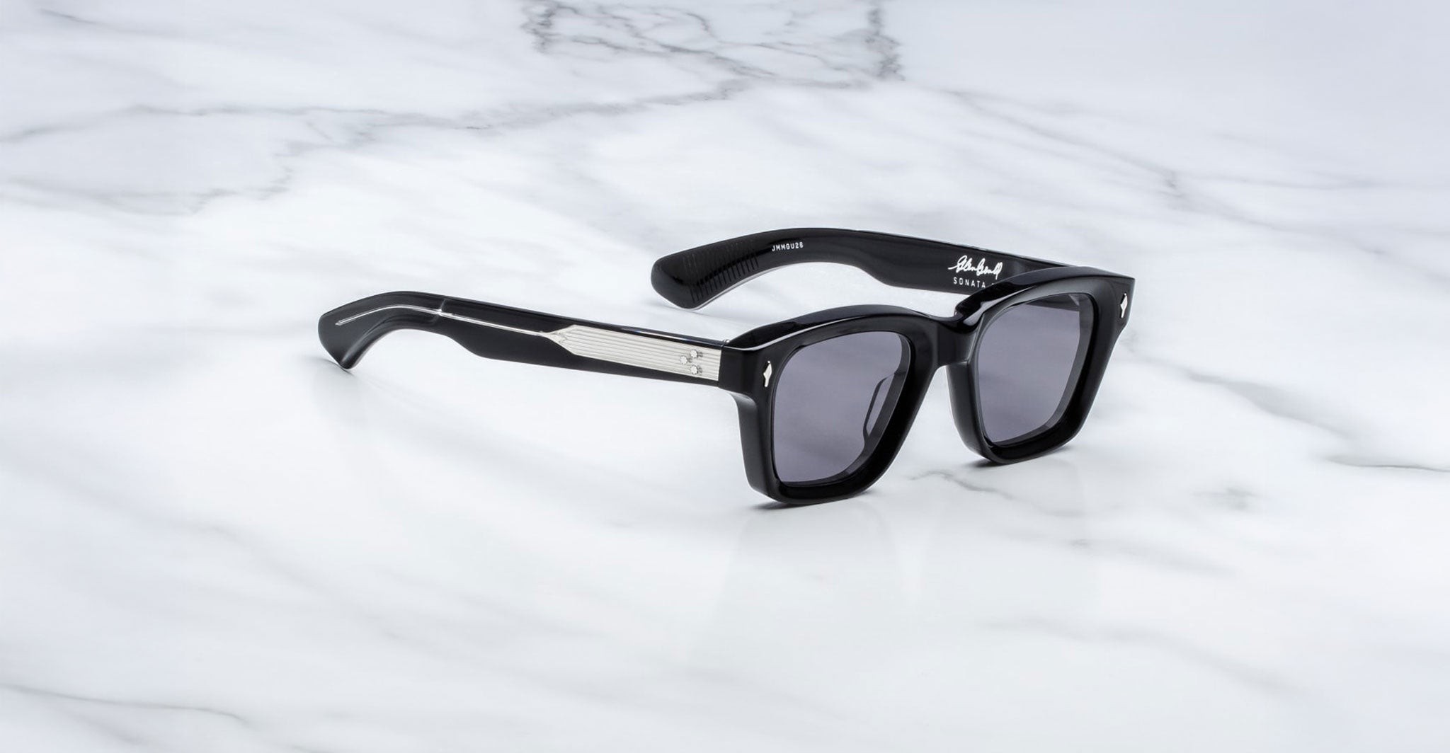 Jacques Marie Mage Sonata black sunglasses with UV-protective dark lenses and silver detailing, front view.