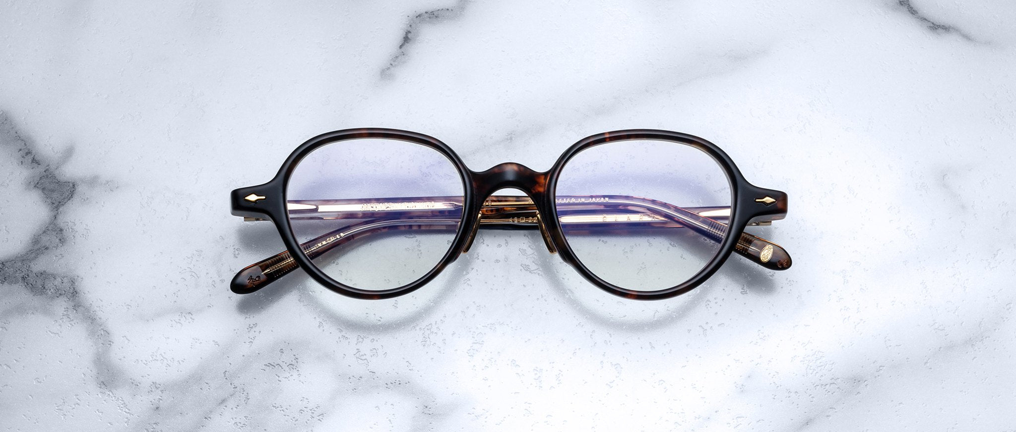 Jacques Marie Mage The Clark eyeglasses with clear lenses, top view, display the brand’s signature design.
